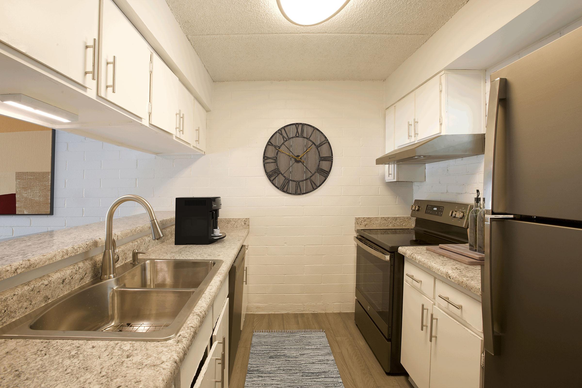 a kitchen with a clock in the middle of a room