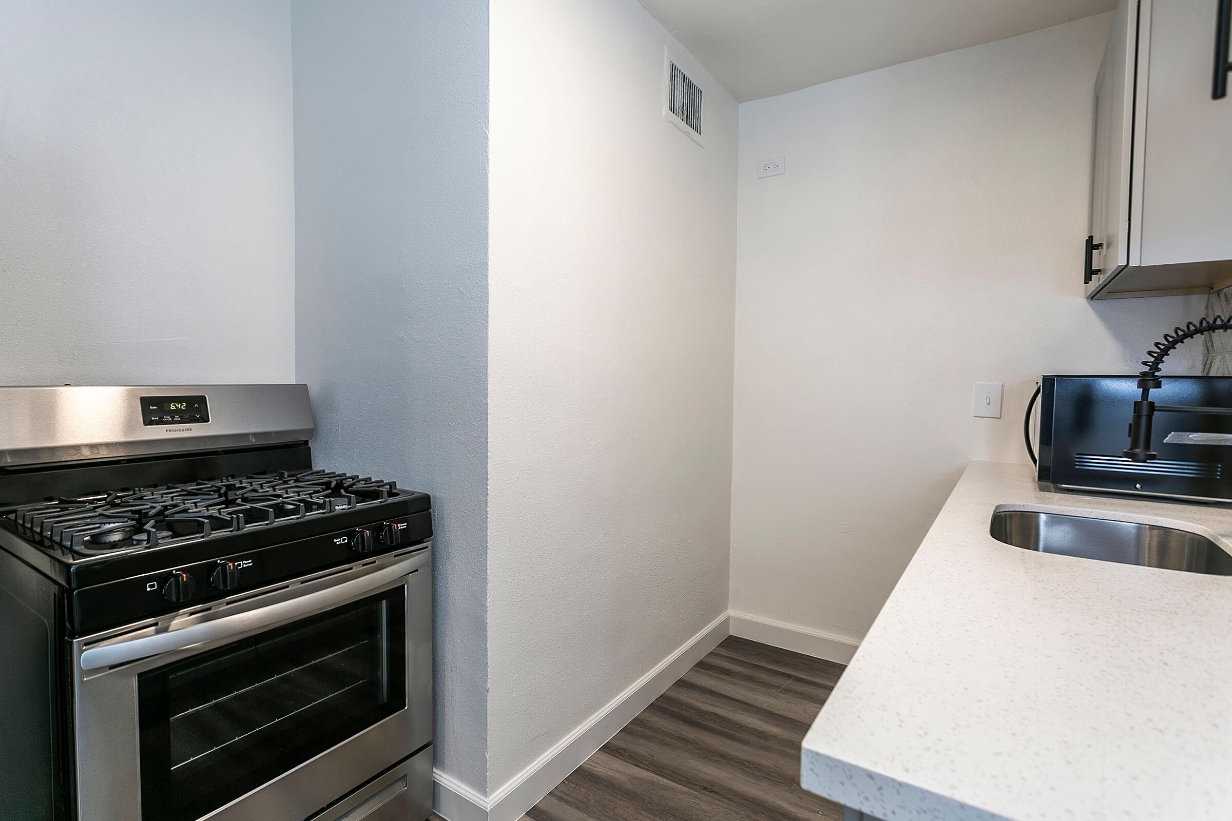 a stove top oven sitting inside of a kitchen