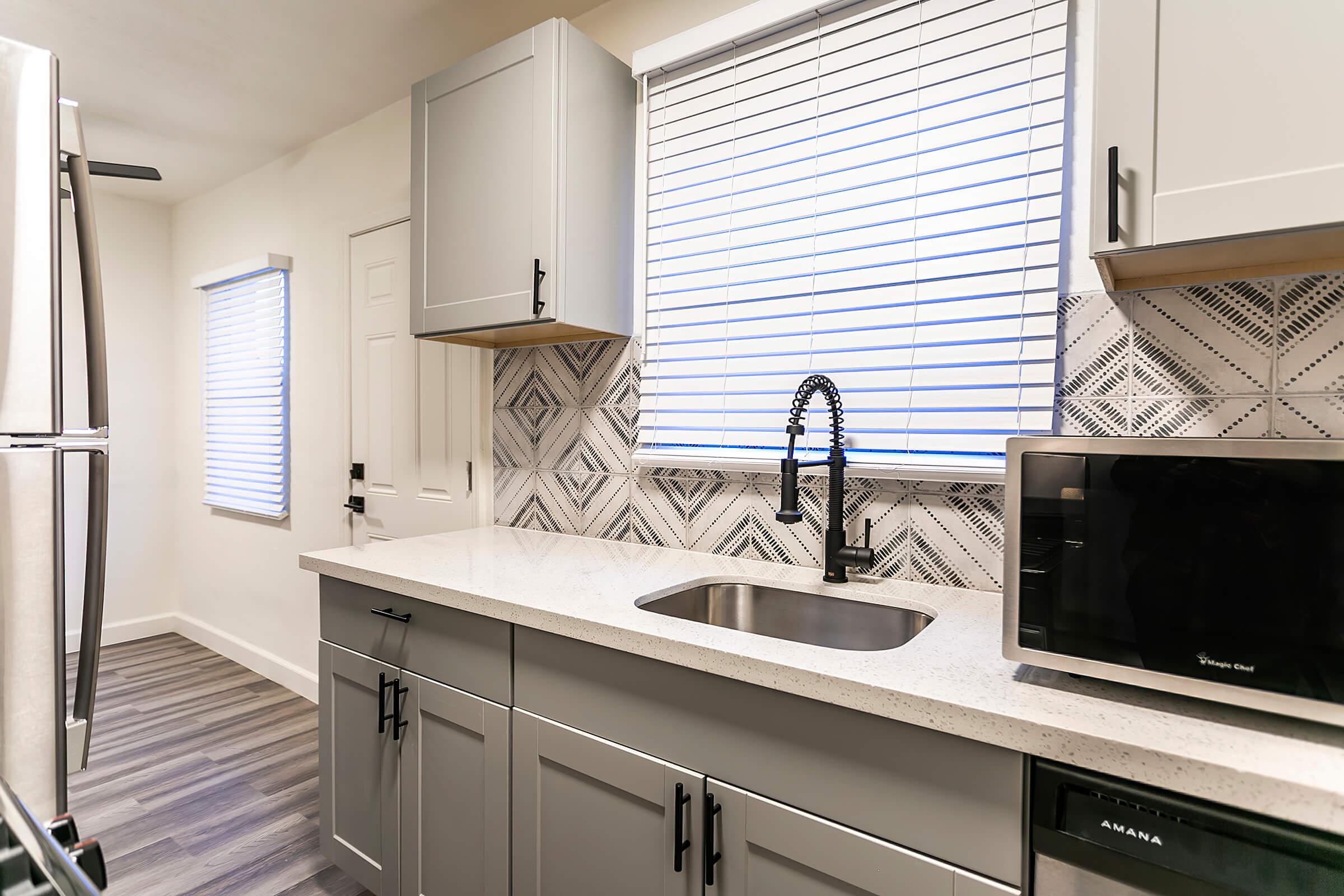 a kitchen with a sink and a window