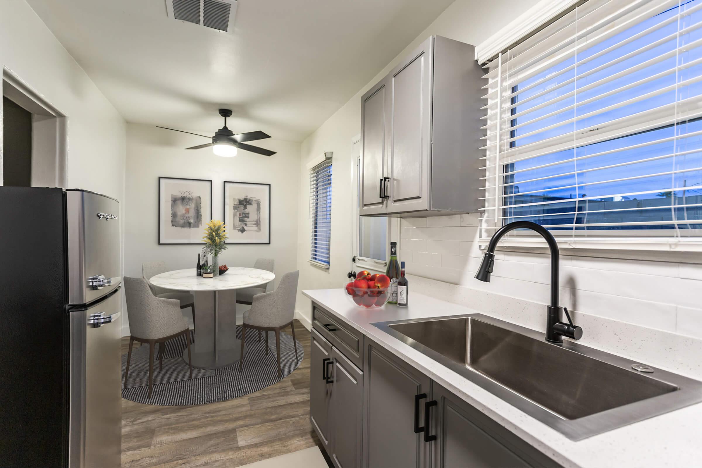 a kitchen with a sink and a mirror