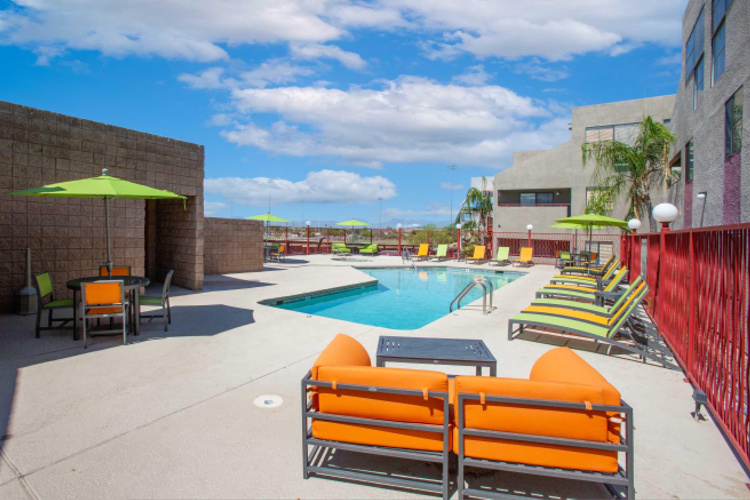 an orange bench in front of a building