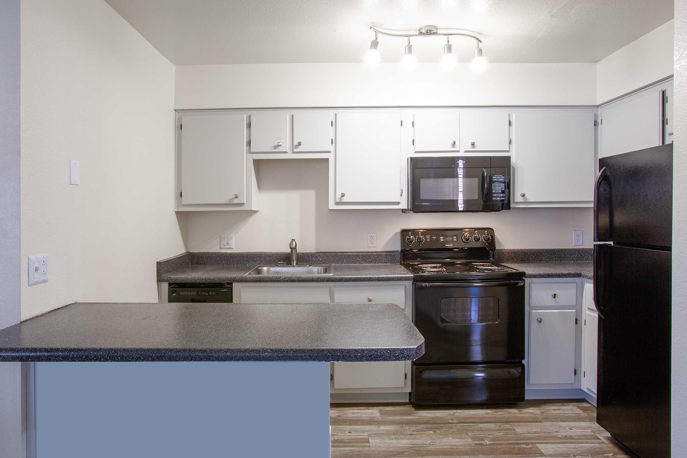 a kitchen with a sink and a microwave