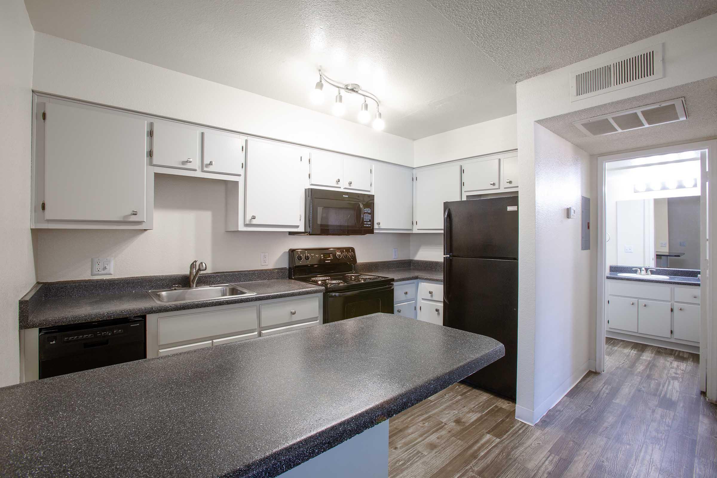 a kitchen with a sink and a mirror