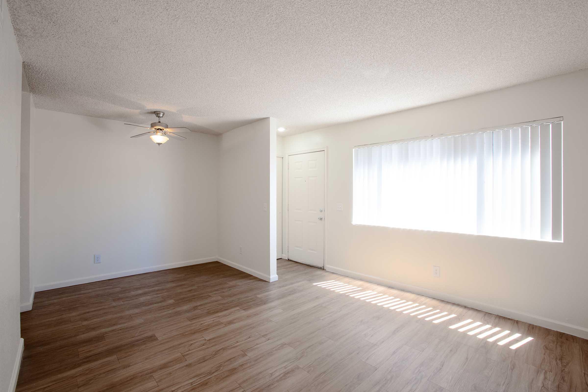 a large empty room with a wooden floor