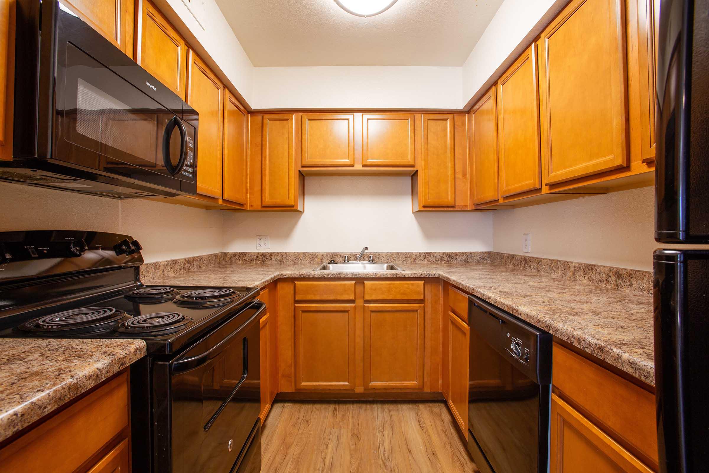 a kitchen with stainless steel appliances and wooden cabinets