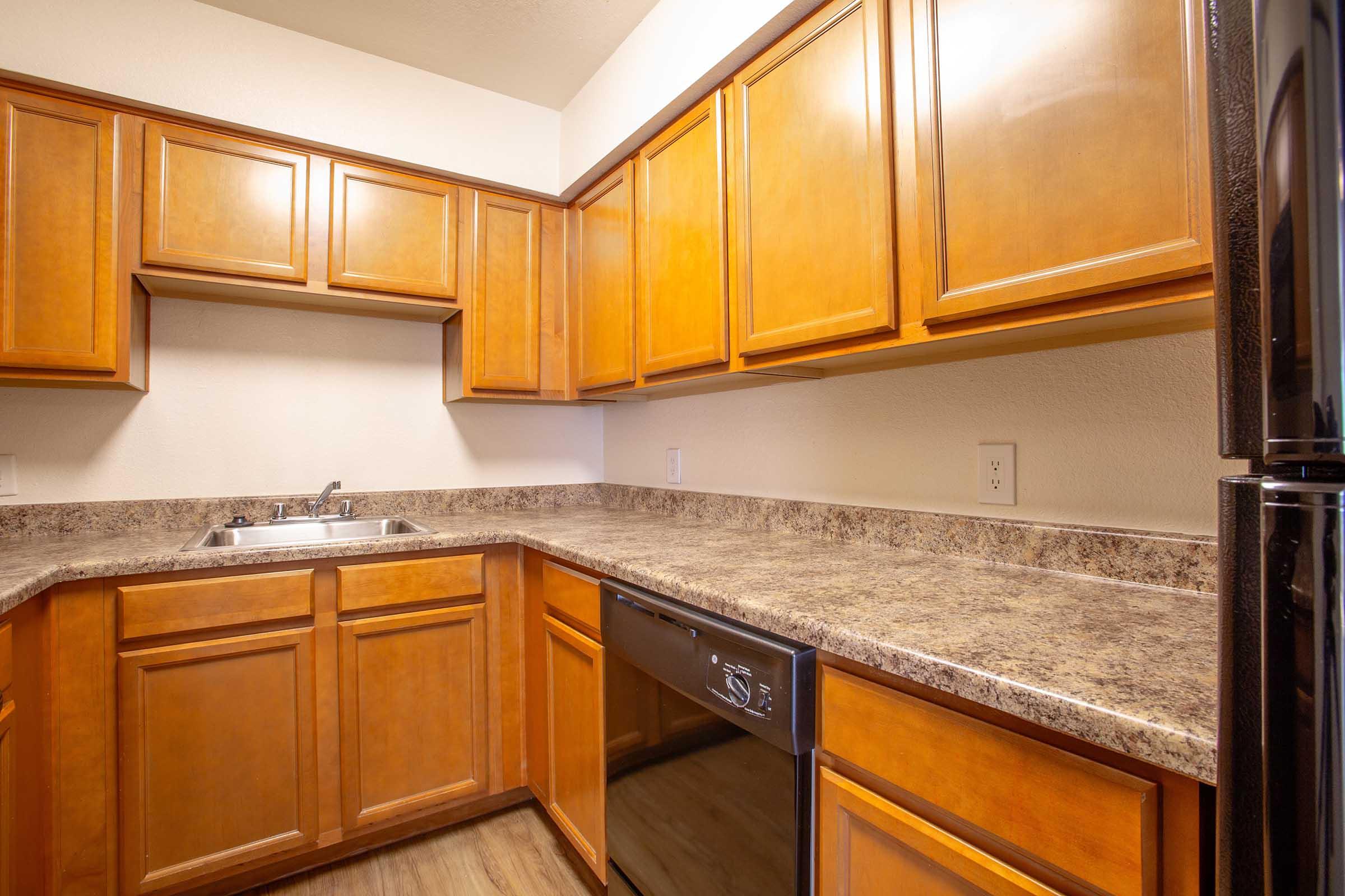 a kitchen with stainless steel appliances and wooden cabinets