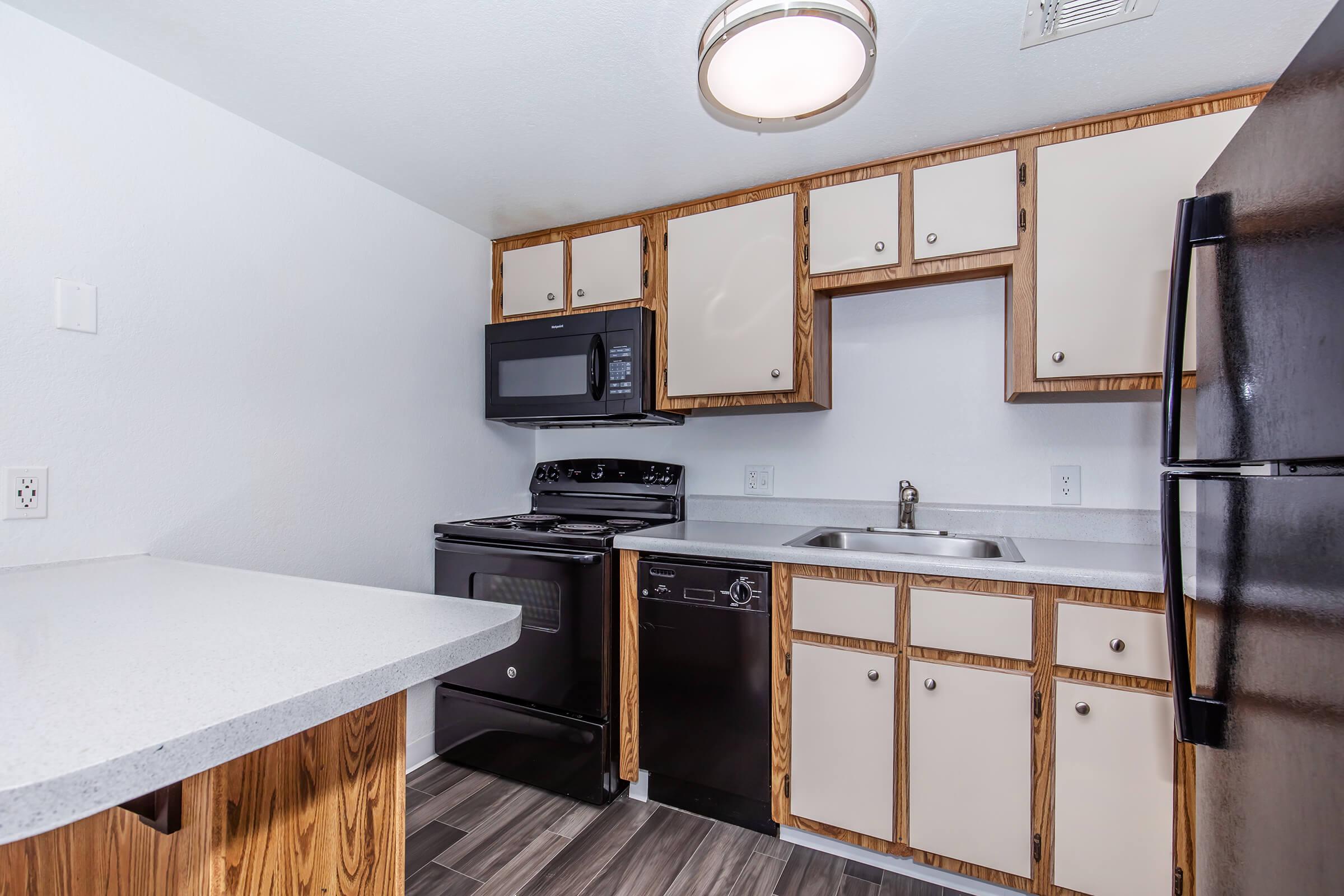 a kitchen with a sink and a mirror