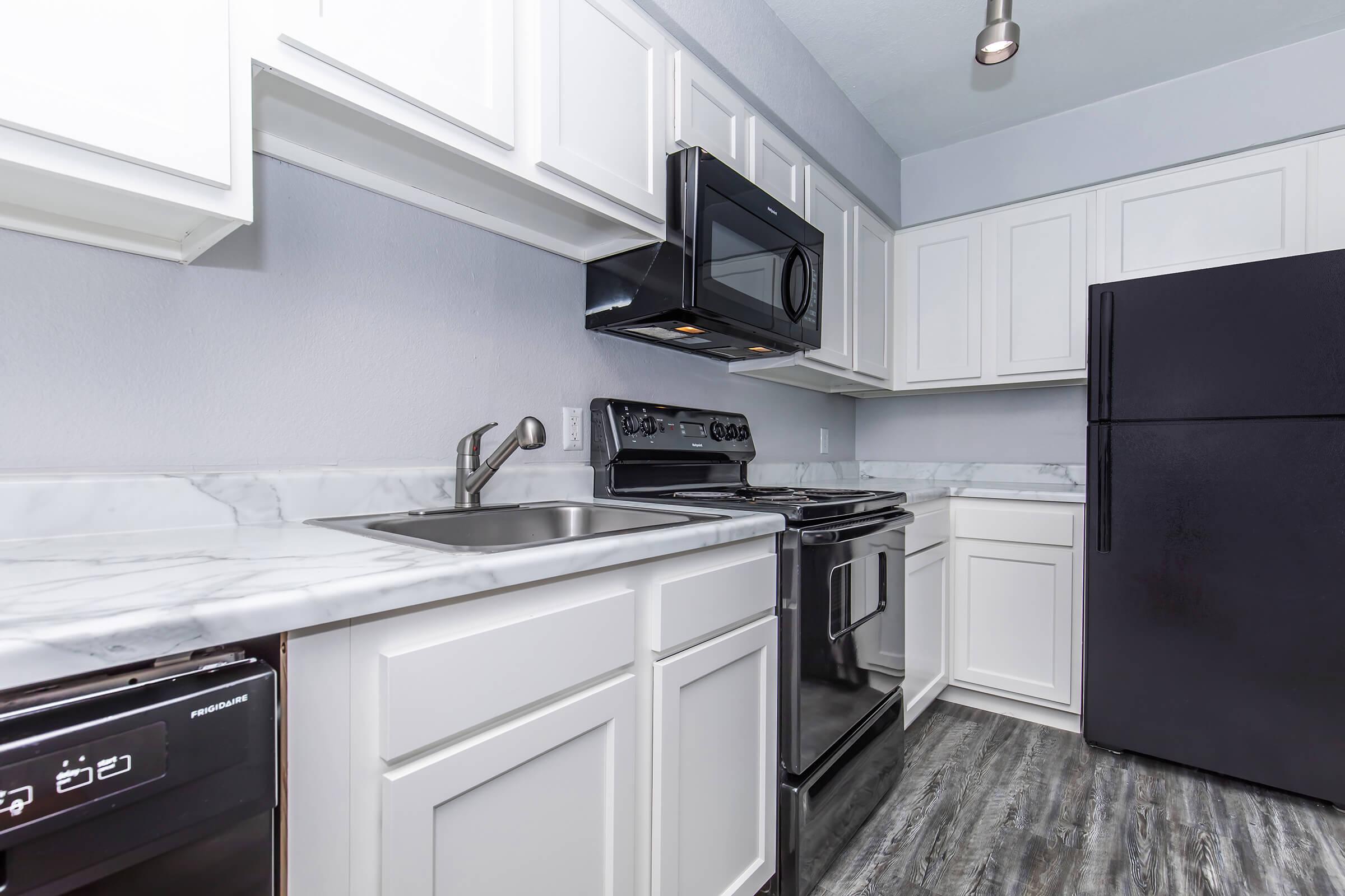 a kitchen with a stove and a refrigerator