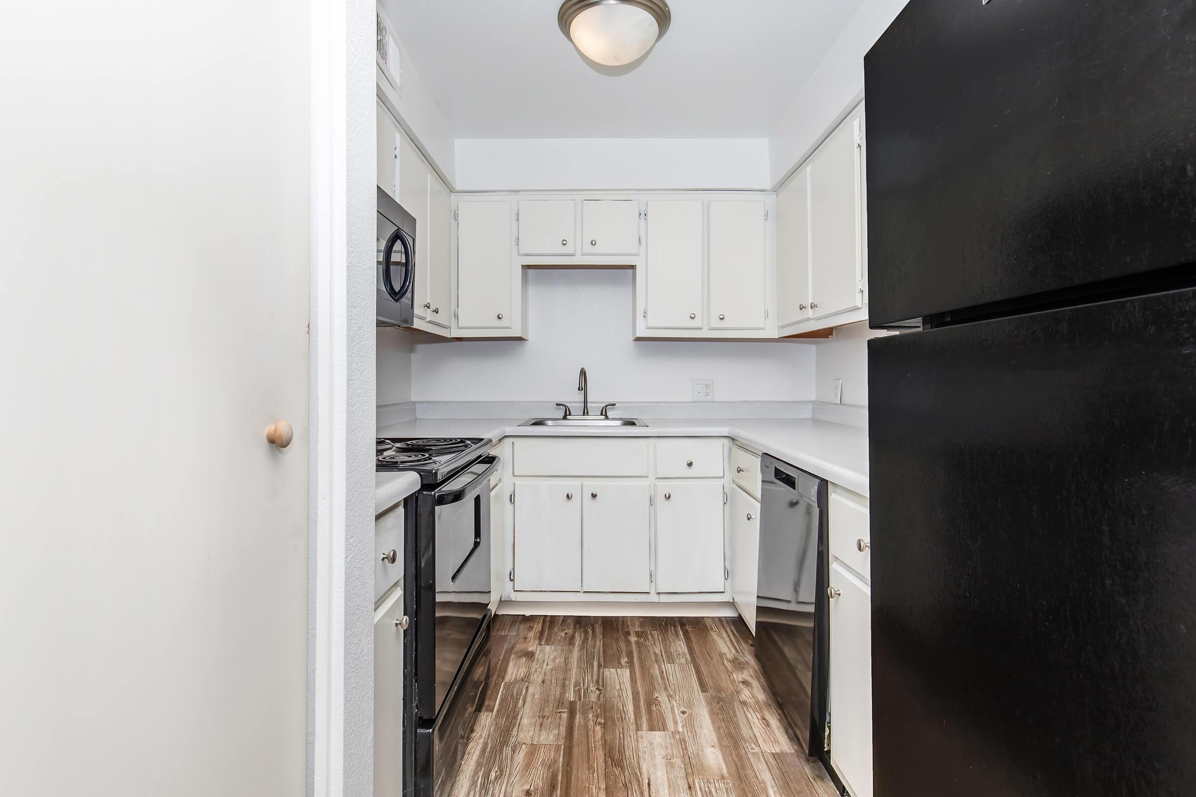 a kitchen with a stove and a refrigerator