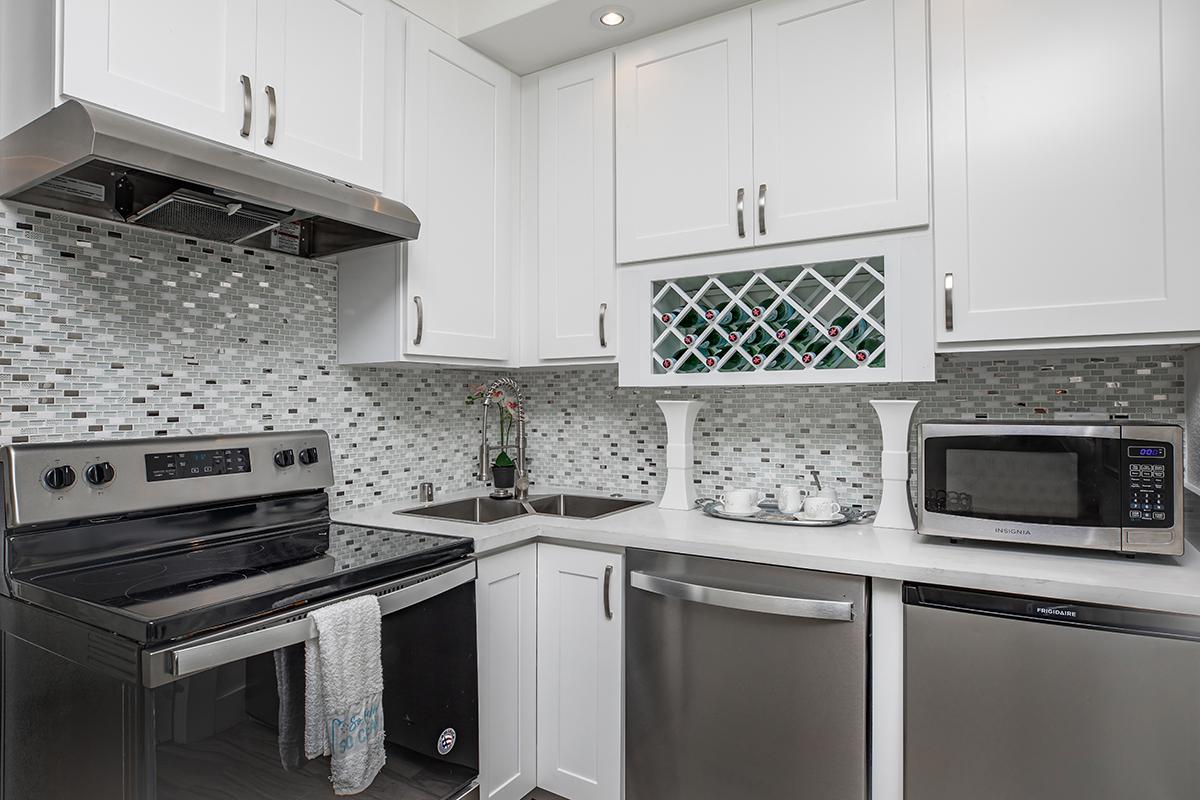 a stove top oven sitting inside of a kitchen