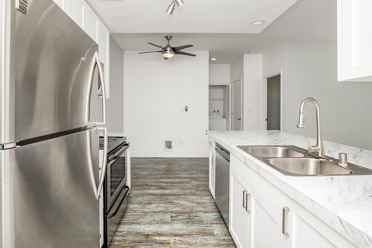 a kitchen with a sink and a refrigerator