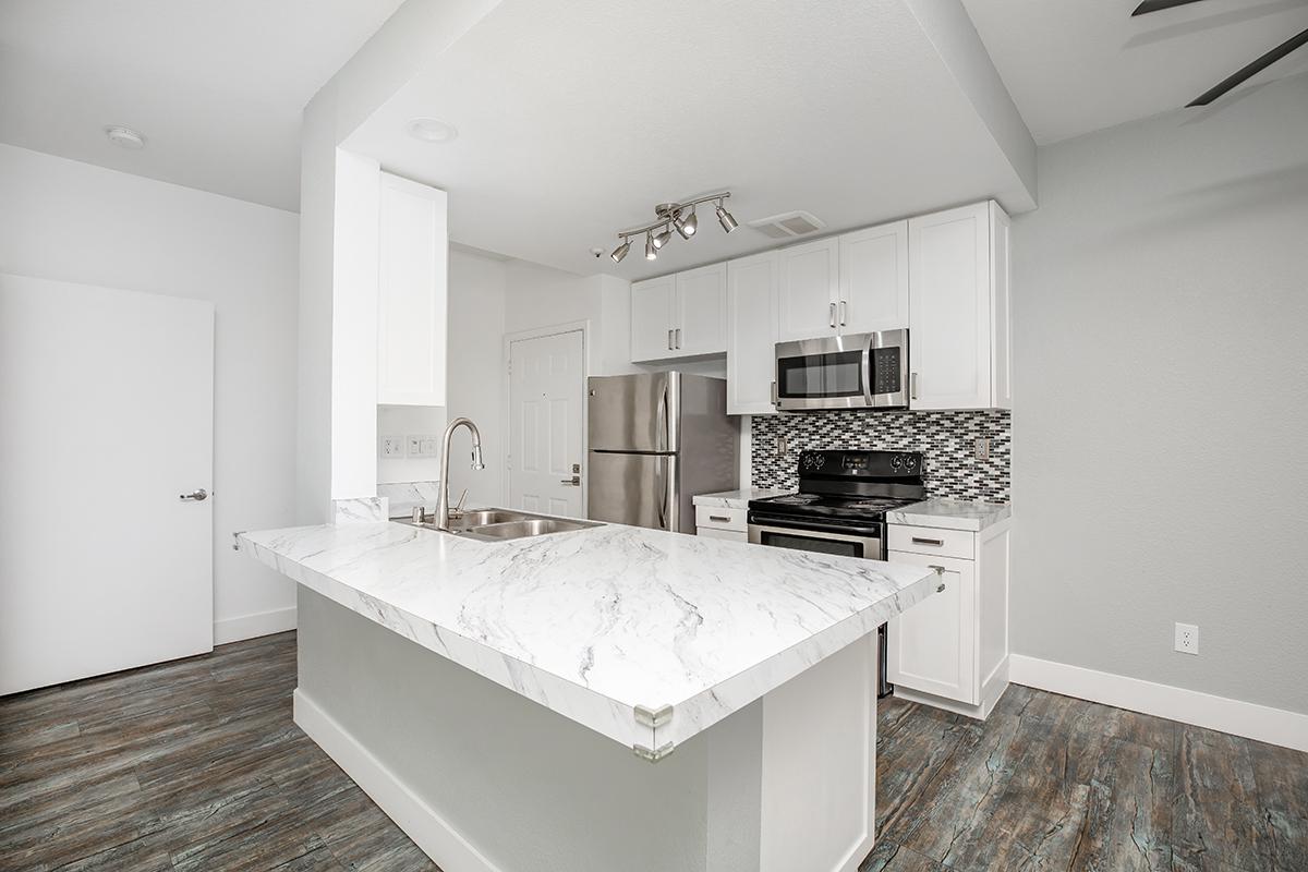 a kitchen with a sink and a mirror