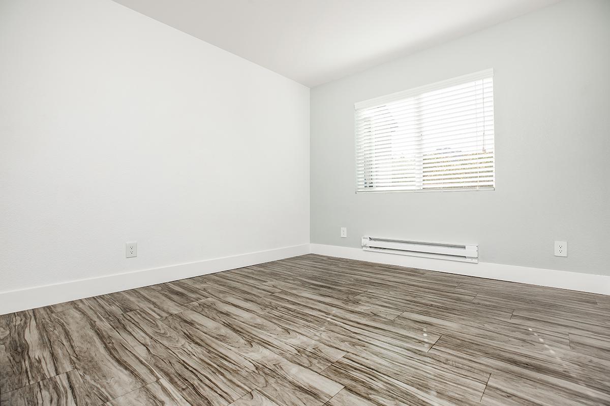 a bedroom with a wooden floor