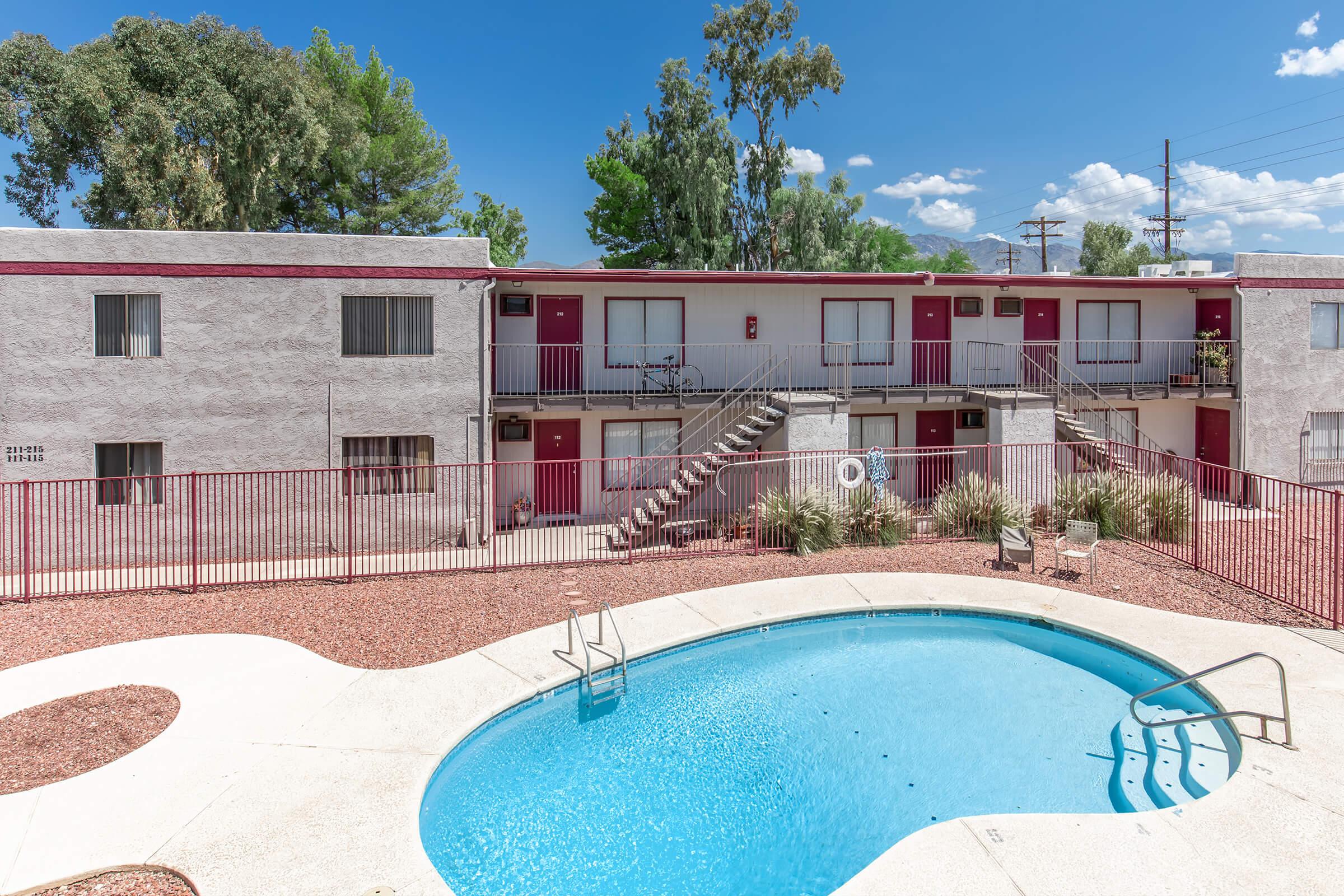 a house with a pool in front of a building