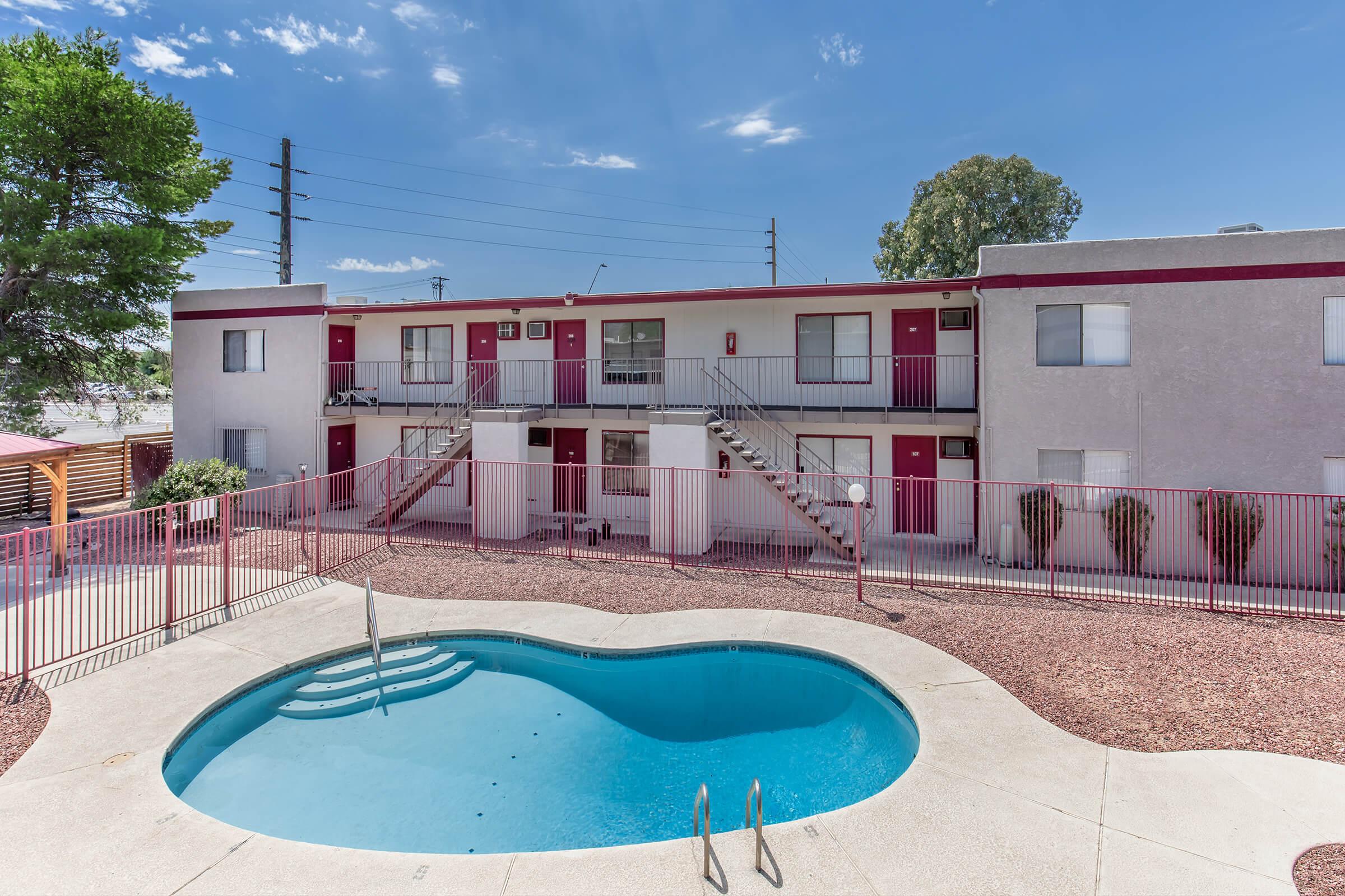 a house with a pool in front of a building