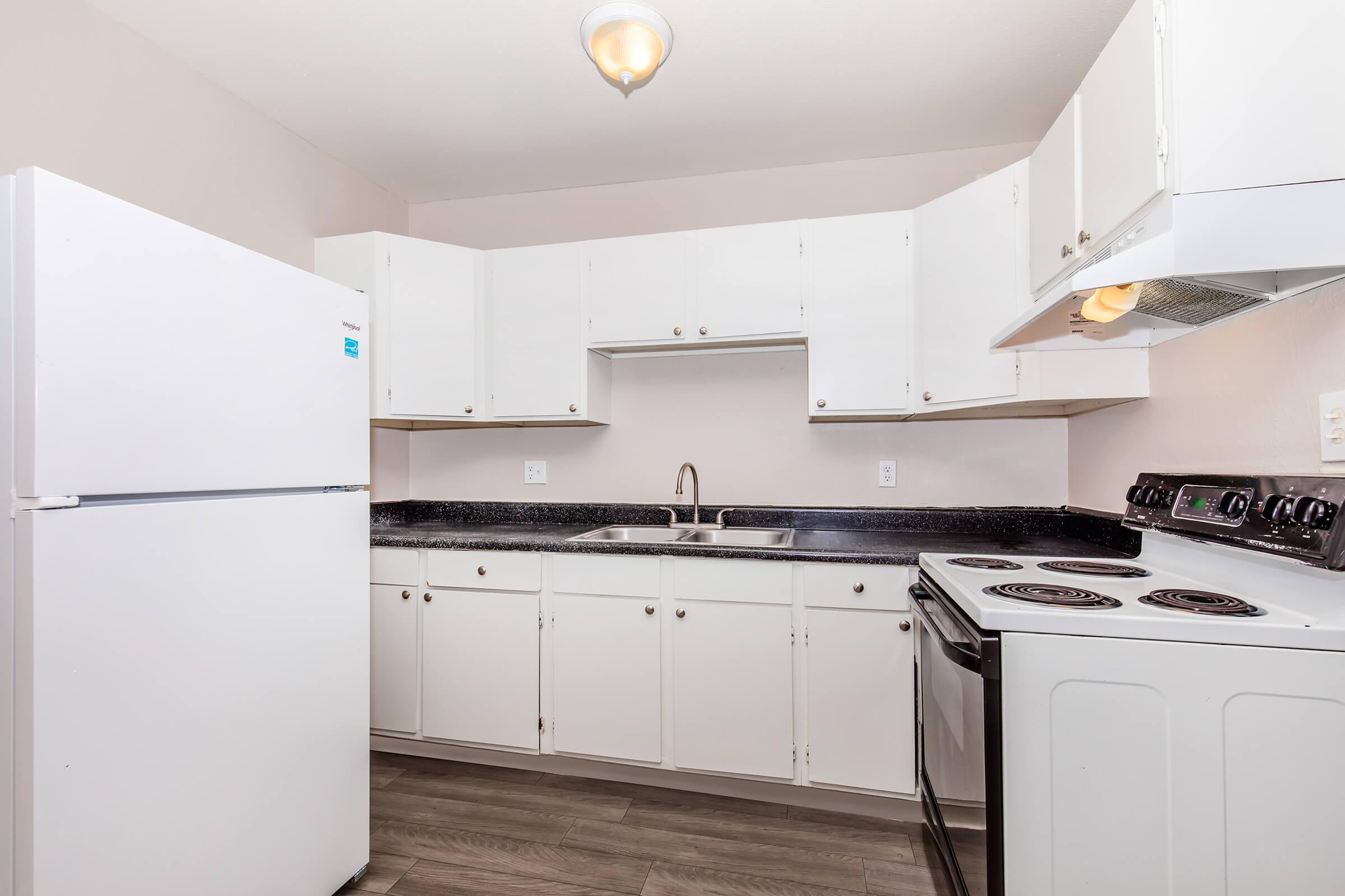 a kitchen with a stove and a refrigerator