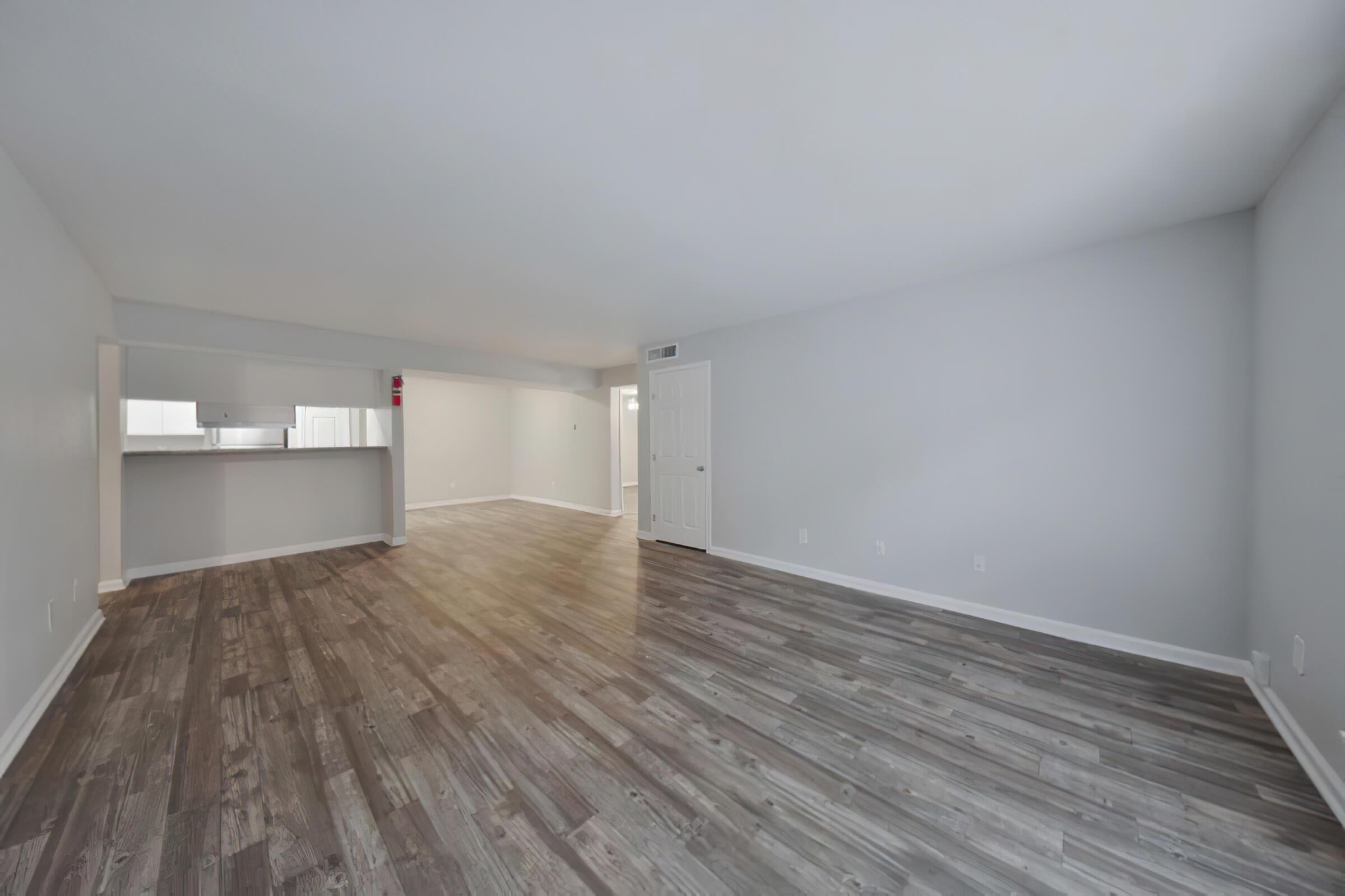 a large empty room with a wooden floor