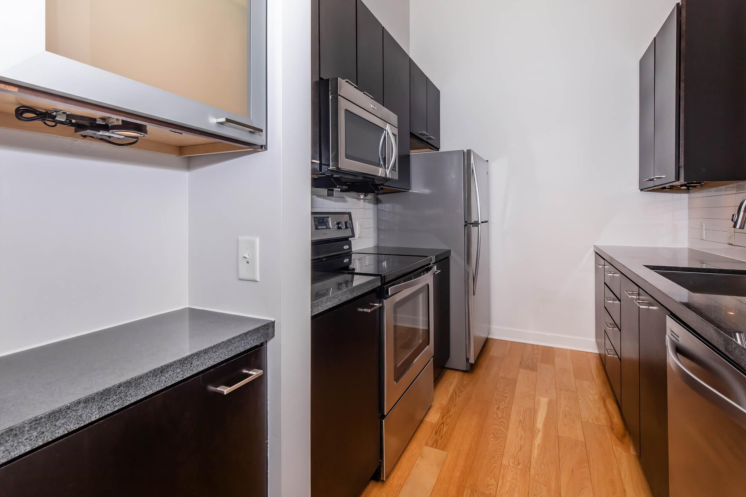 a kitchen with stainless steel appliances and wooden cabinets