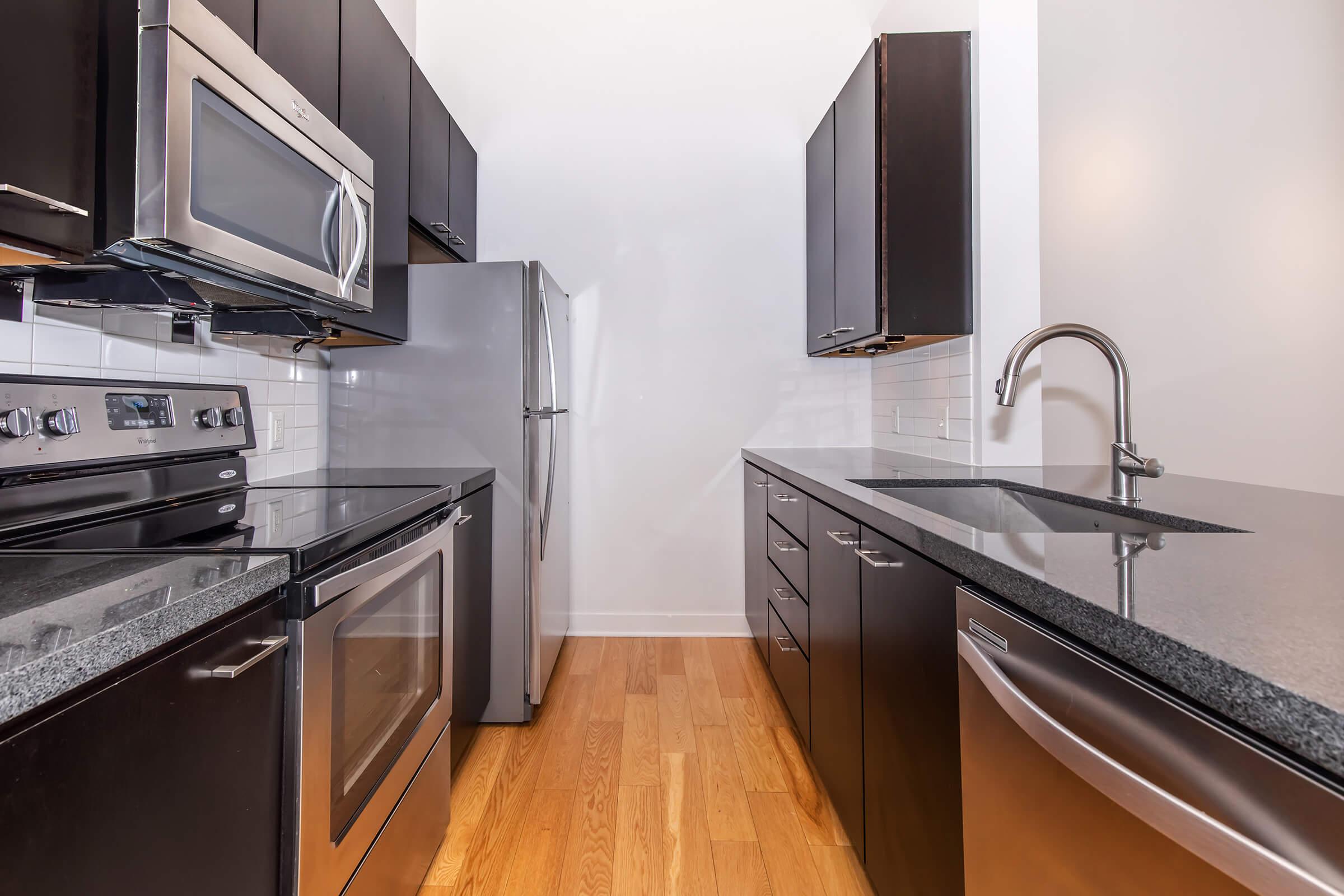 a kitchen with stainless steel appliances and wooden cabinets