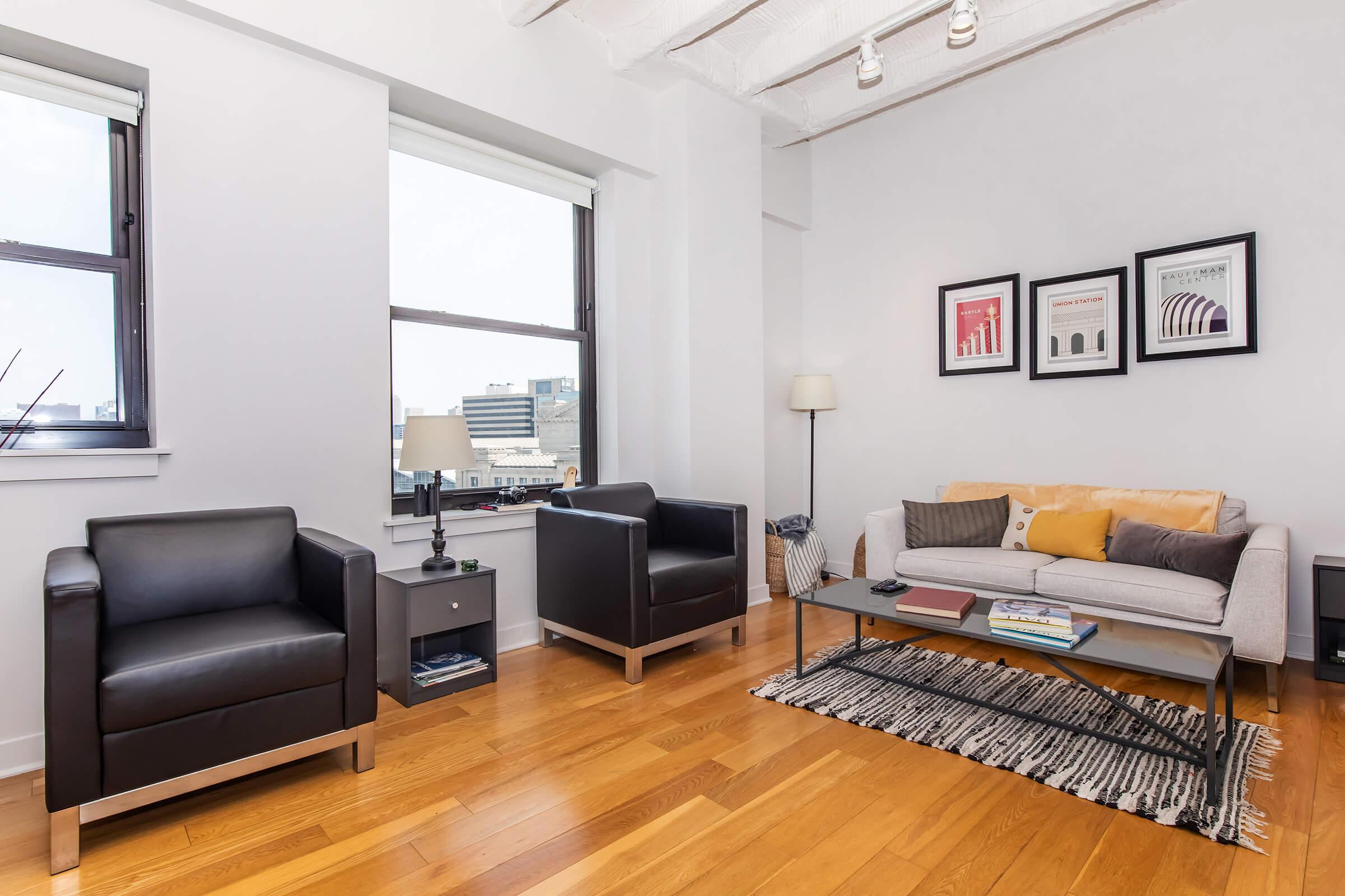 a living room filled with furniture and a flat screen tv