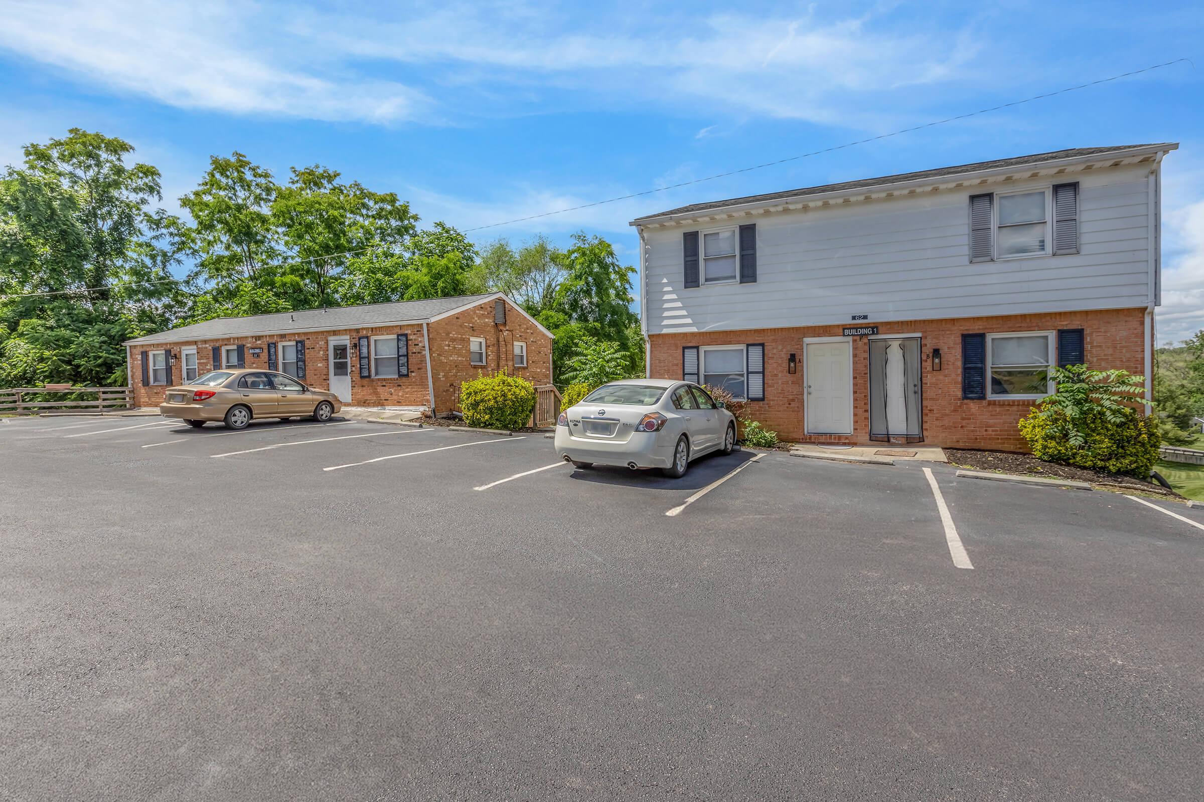 an empty parking lot in front of a house