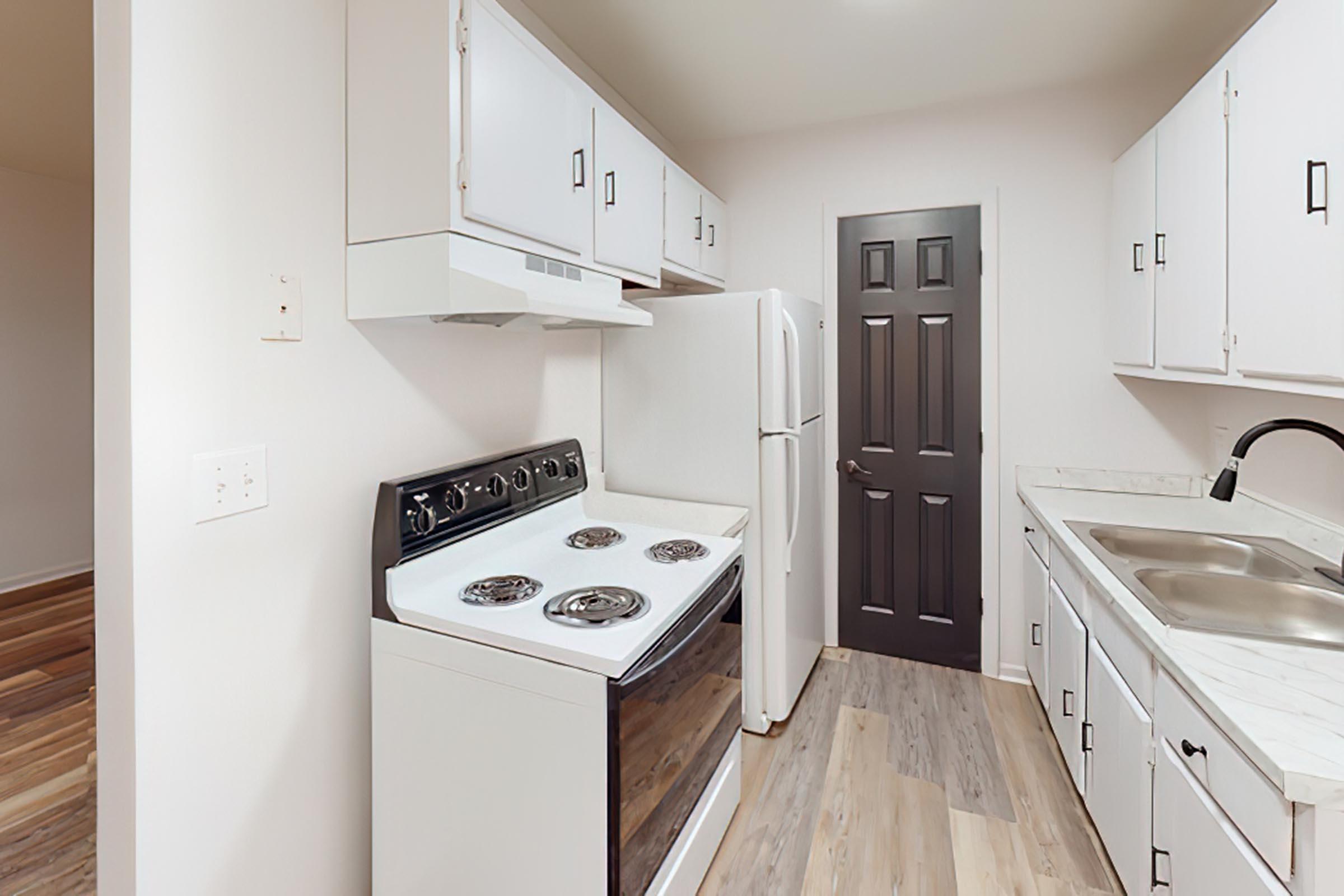 a kitchen with a stove top oven sitting inside of a refrigerator