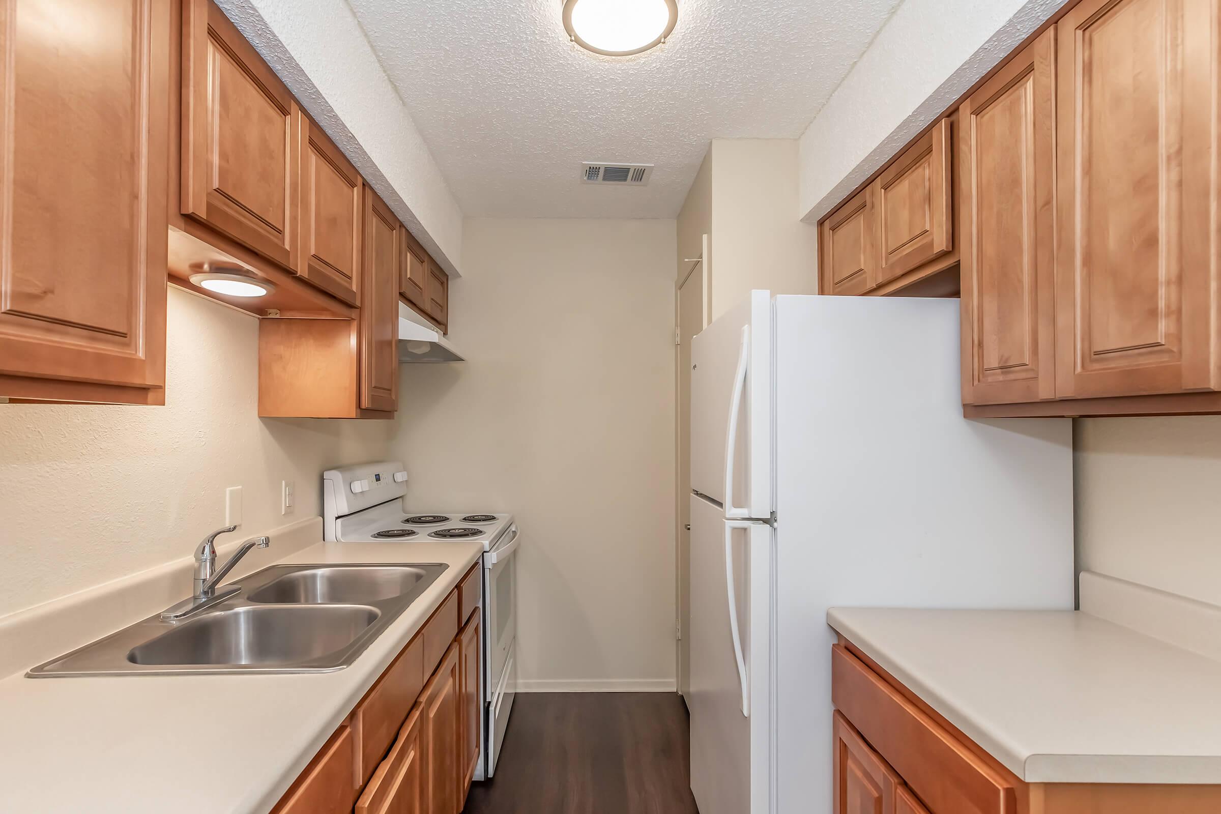 a kitchen with a stove sink and refrigerator