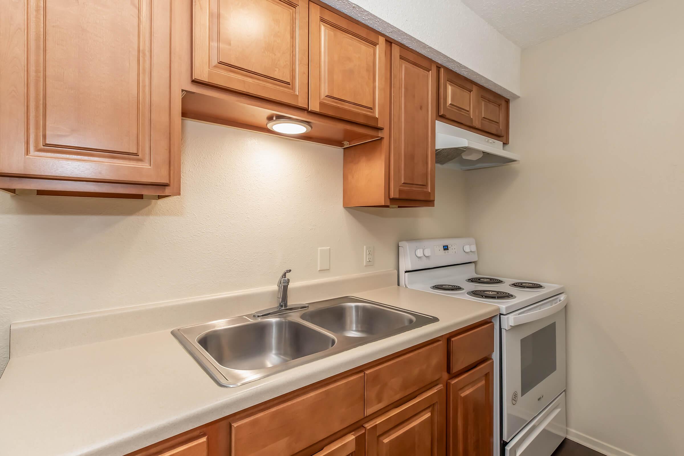 a kitchen with a stove a sink and a microwave