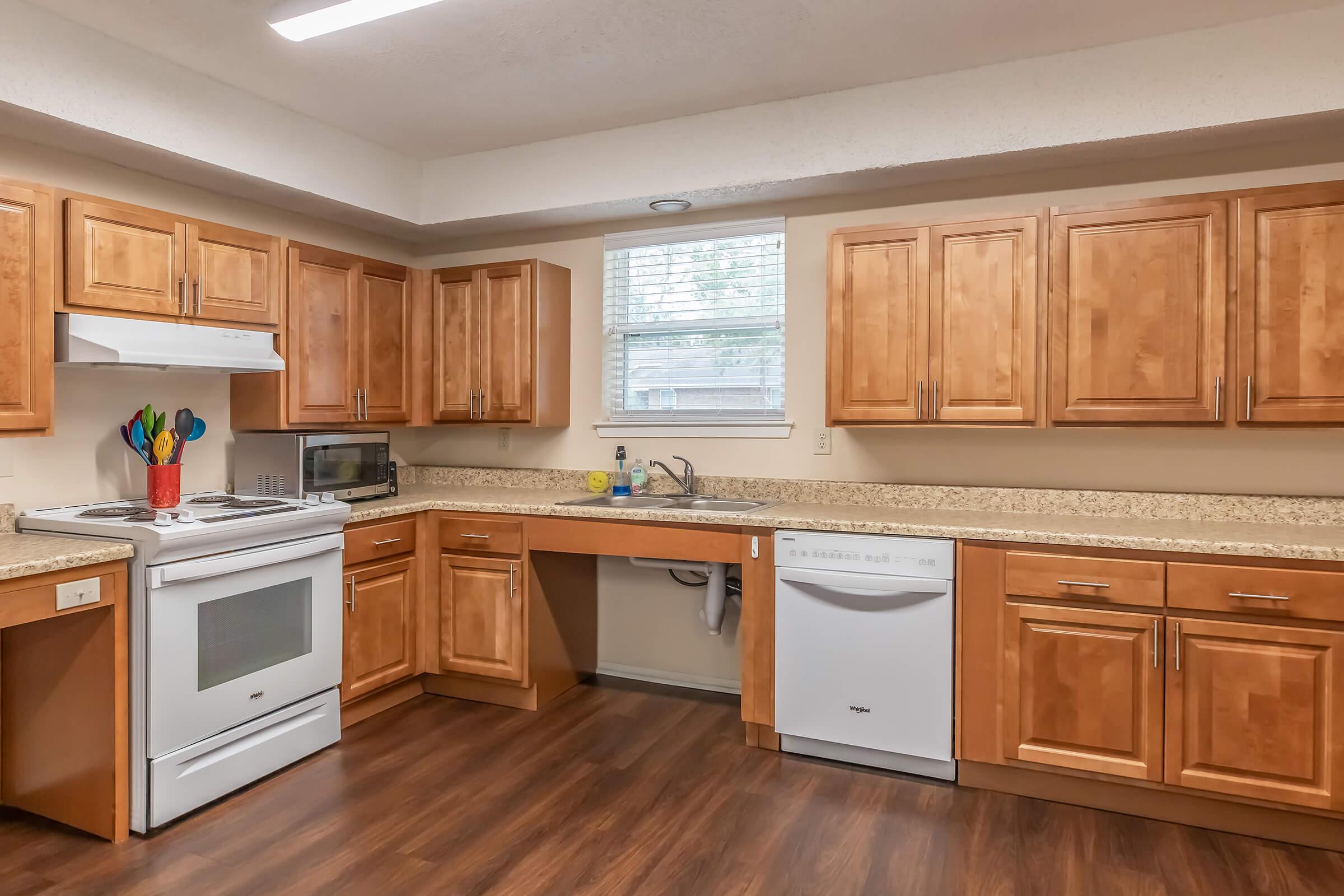 a kitchen with stainless steel appliances and wooden cabinets