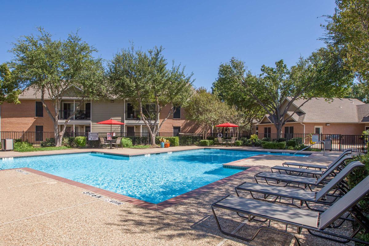 a house with a pool outside of a building