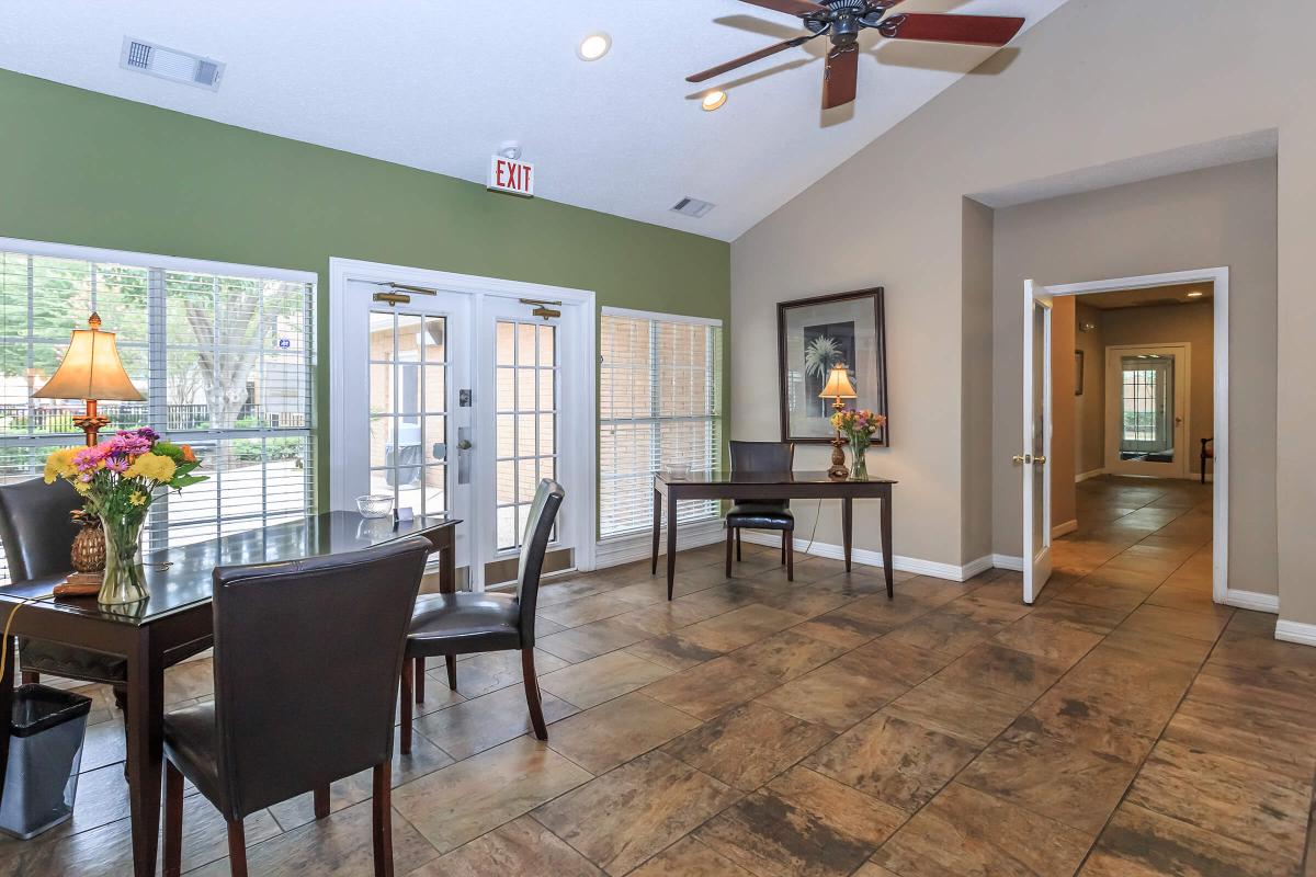 a living room filled with furniture and a large window