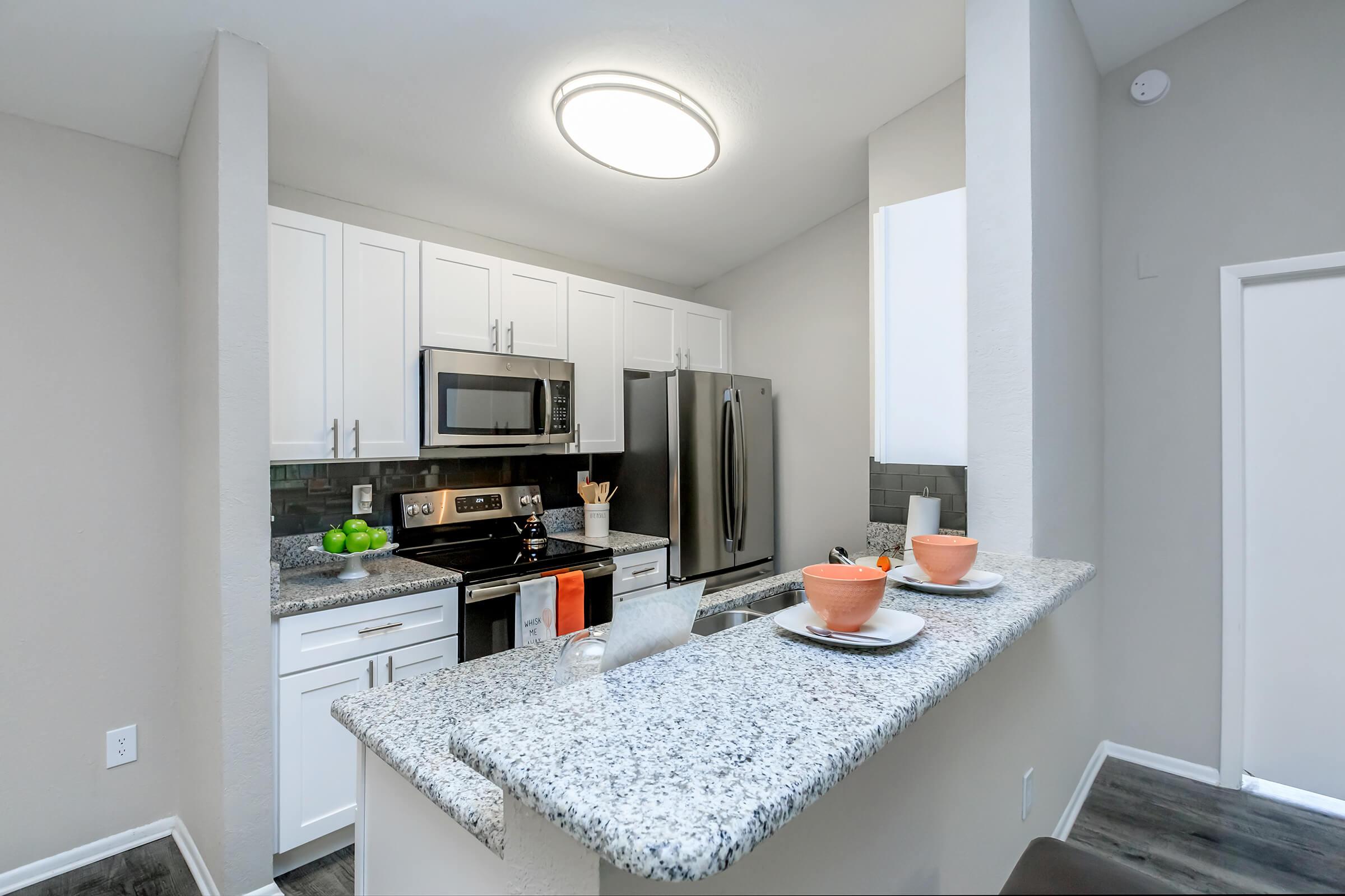 a kitchen with a sink and a mirror