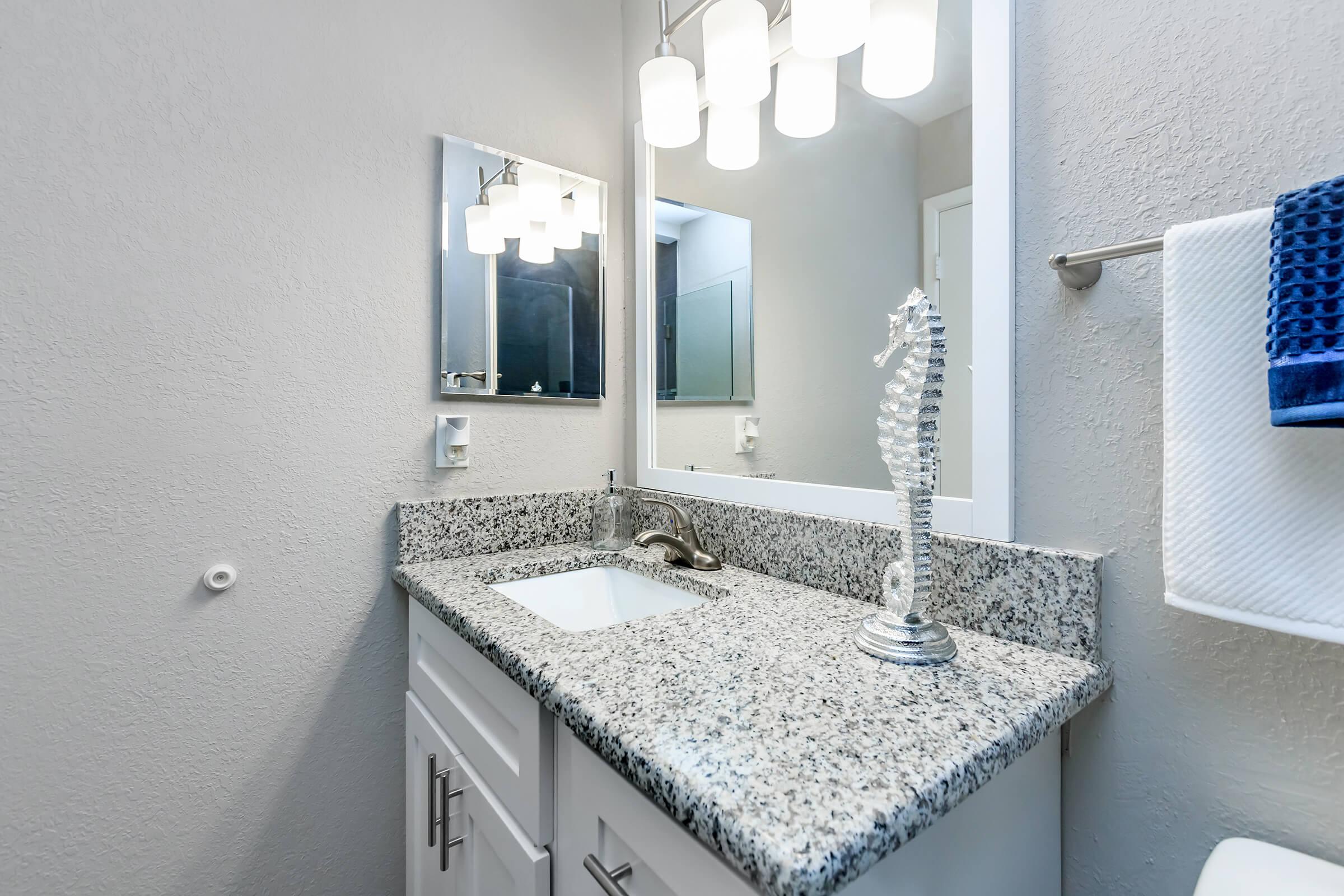 a room with a sink and a mirror