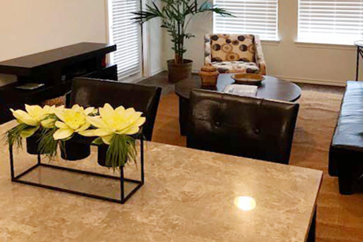 a living room filled with furniture and vase of flowers on a table