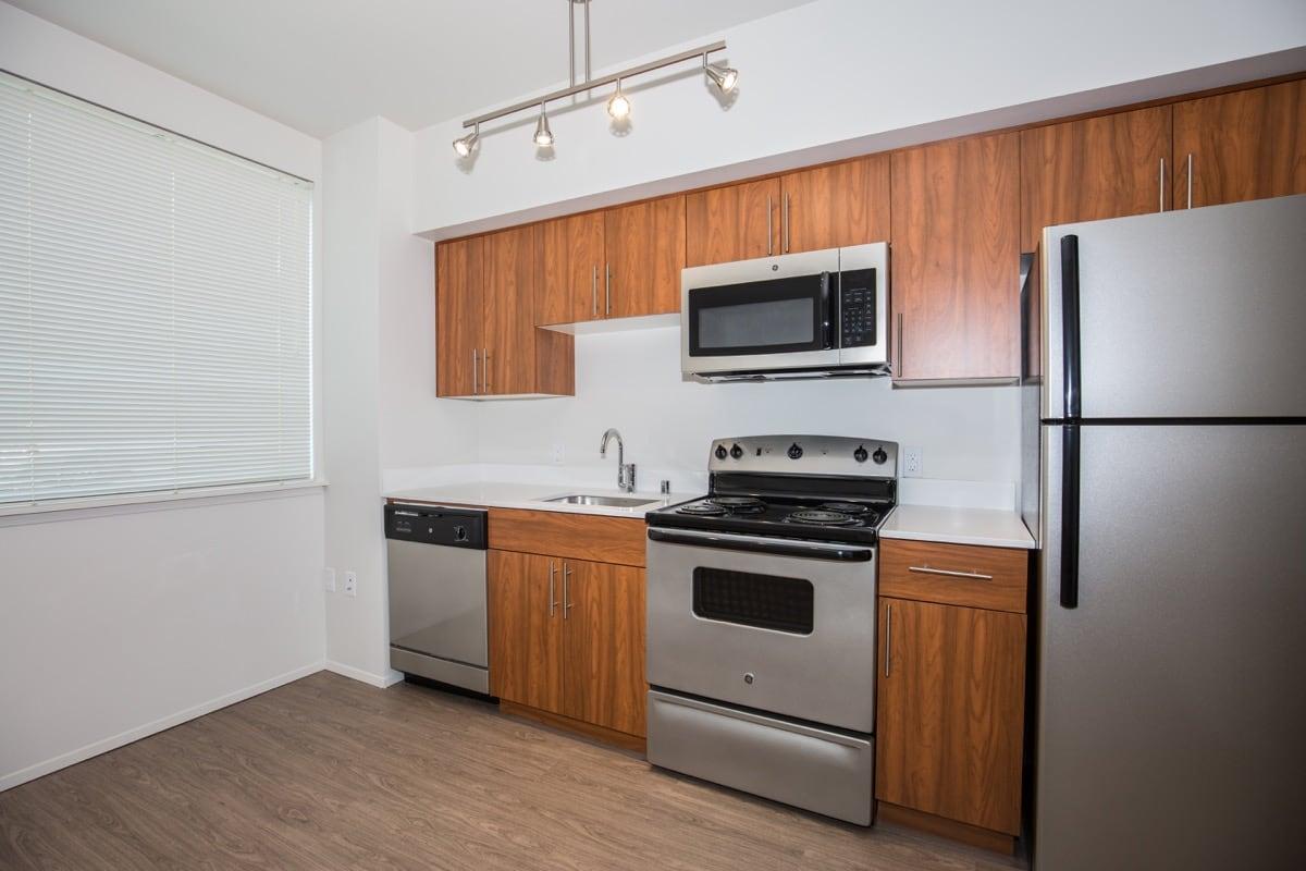 a kitchen with stainless steel appliances and wooden cabinets