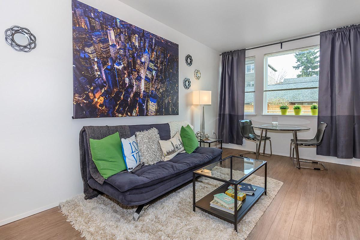 a living room filled with furniture and a large window