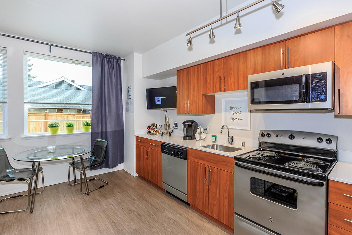 a kitchen with stainless steel appliances and wooden cabinets