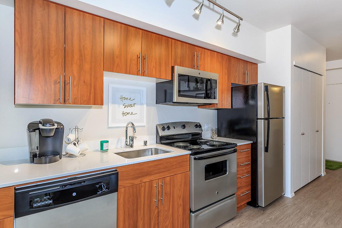 a kitchen with stainless steel appliances and wooden cabinets