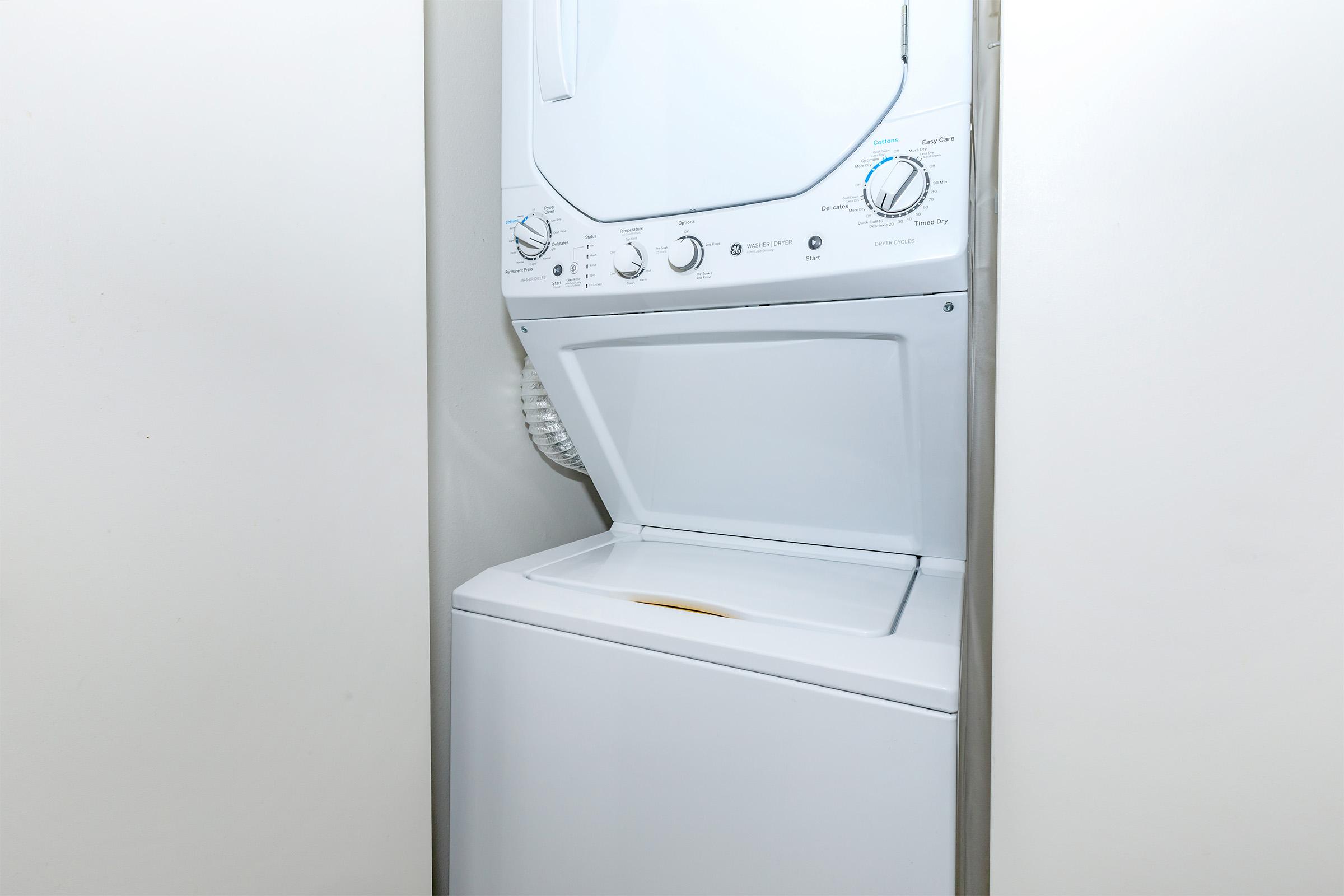 a microwave oven sitting on top of a refrigerator