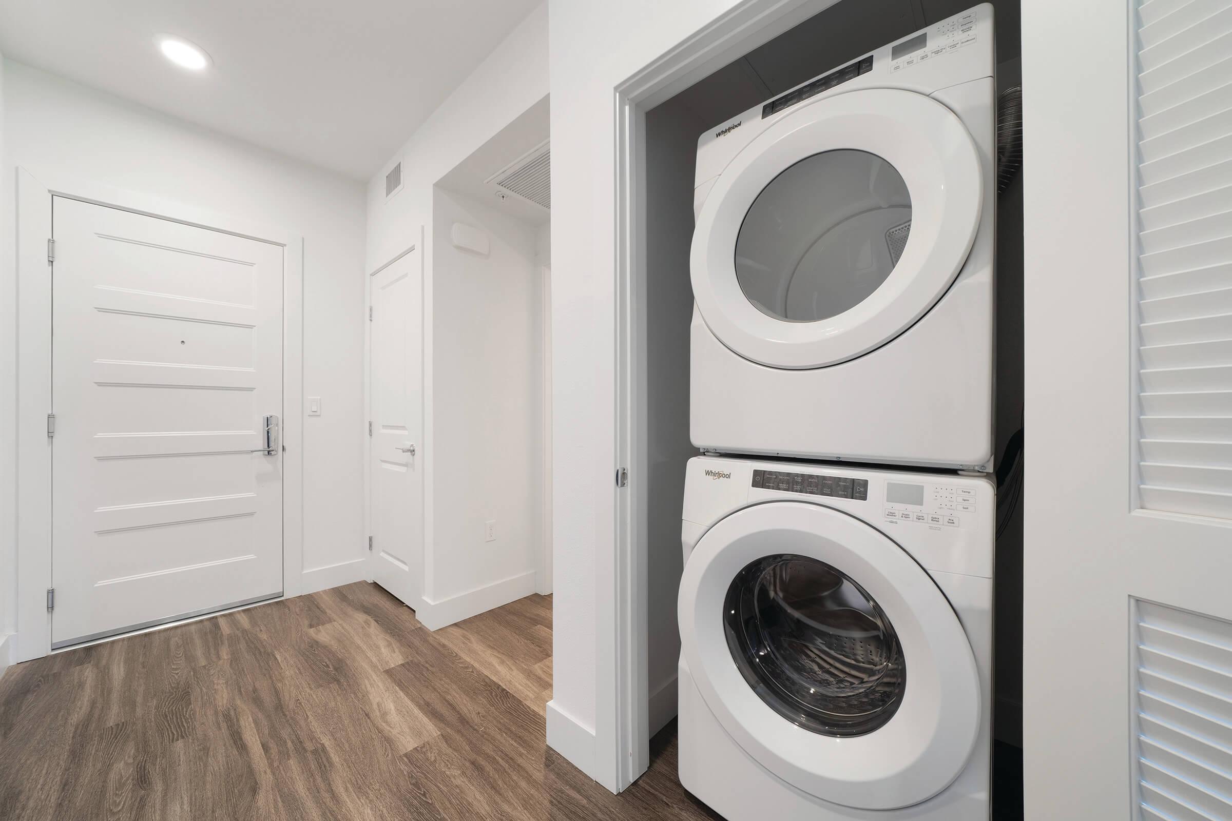 Stacked washer and dryer with front door