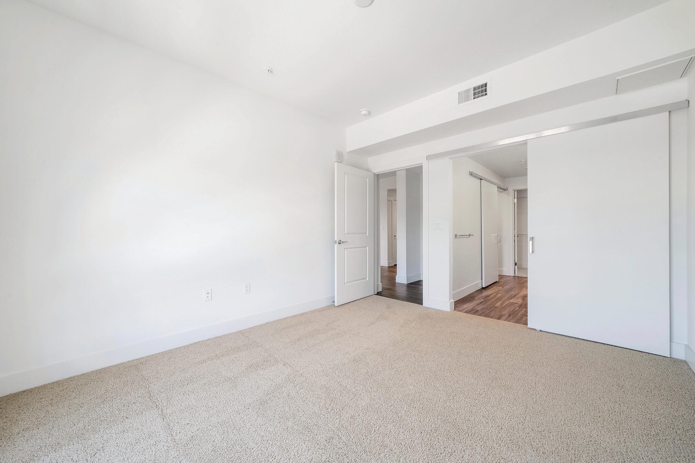 a bedroom with a building in the background