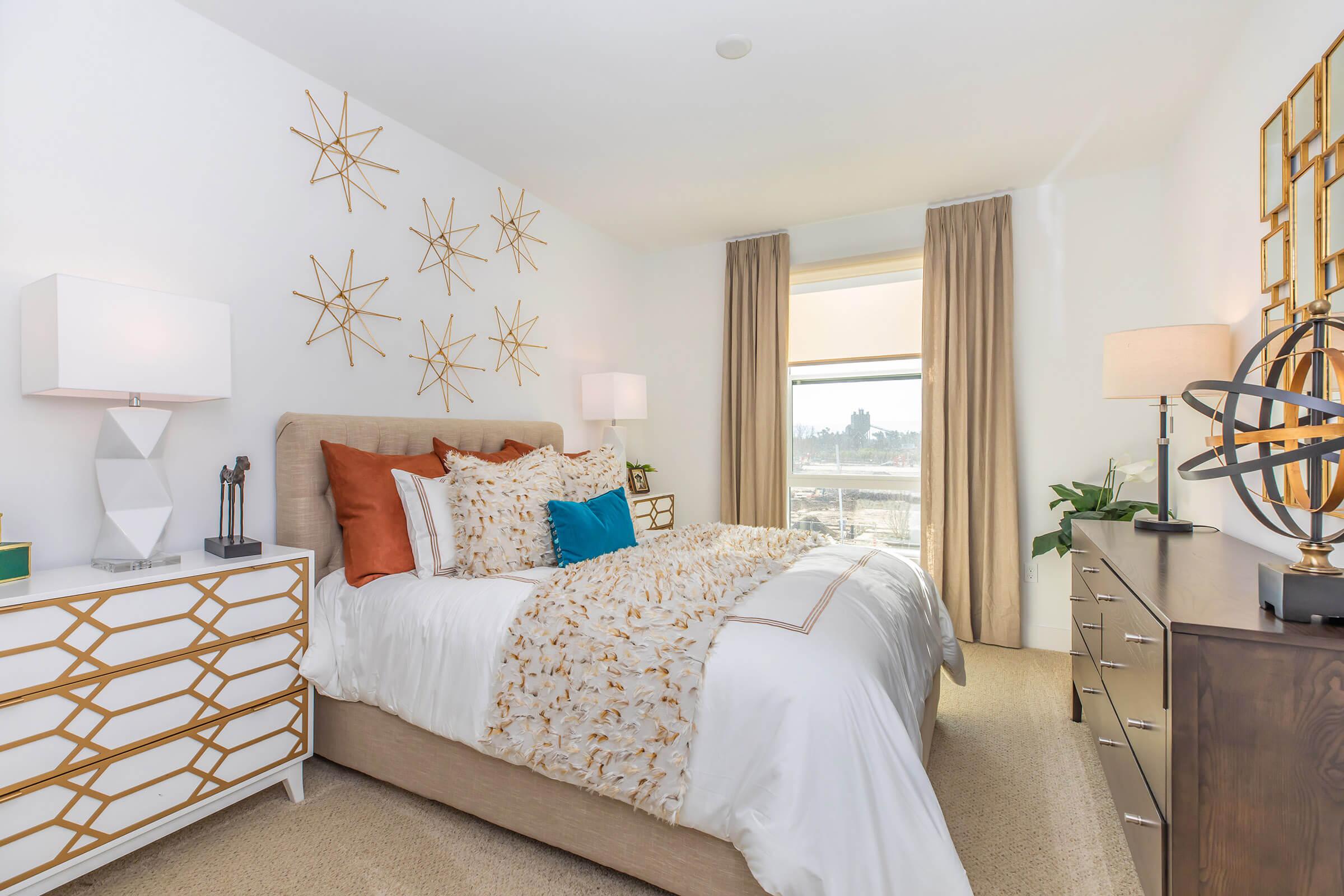 a bedroom with a bed and desk in a room