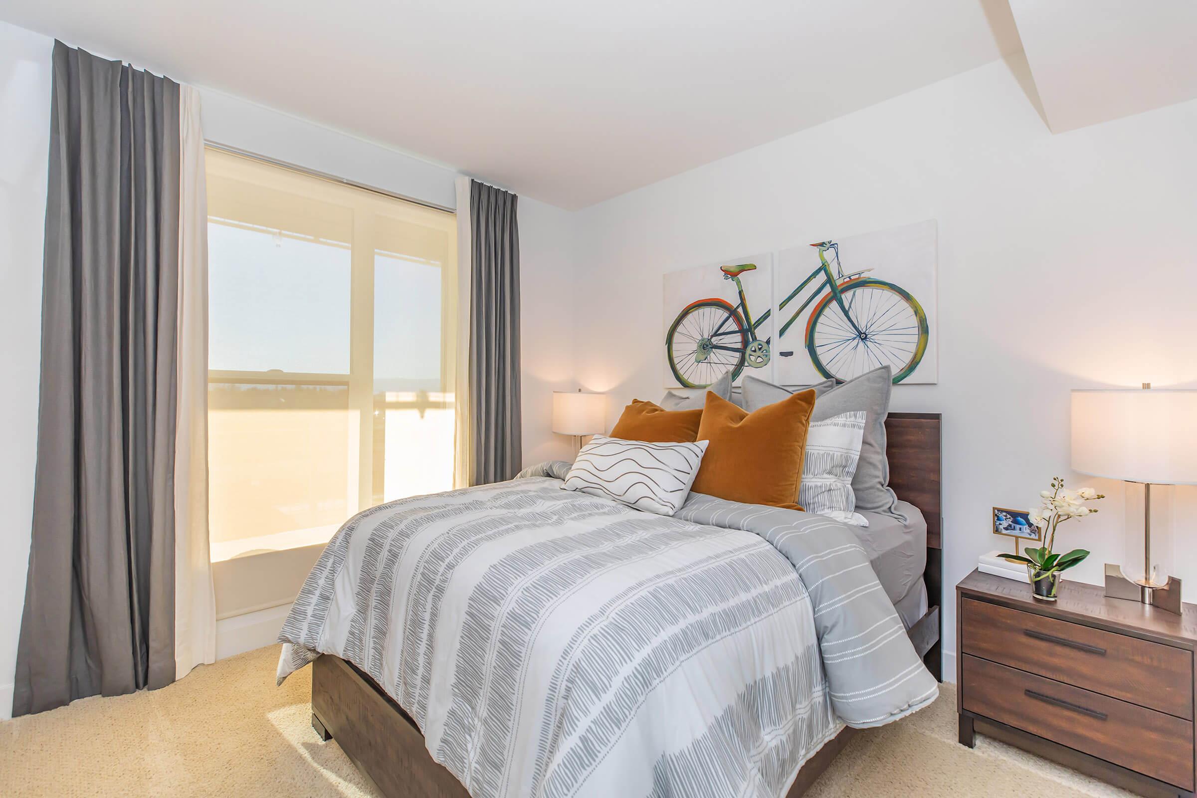 Furnished bedroom with bicycle artwork