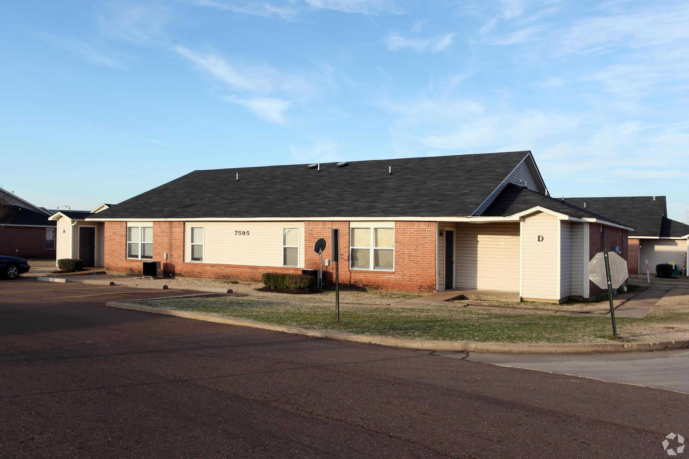 an empty road in front of a house