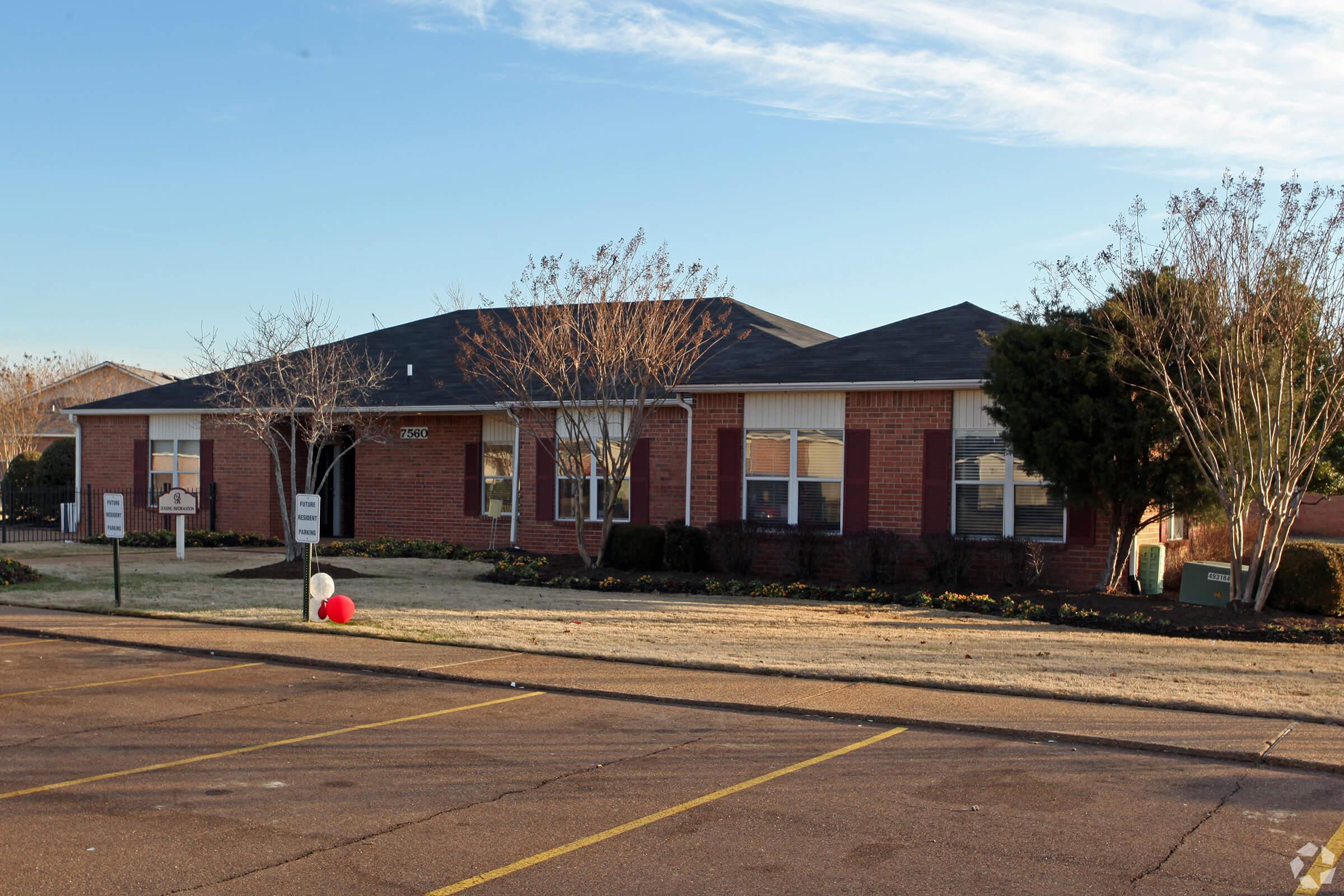 an empty parking lot in front of a house
