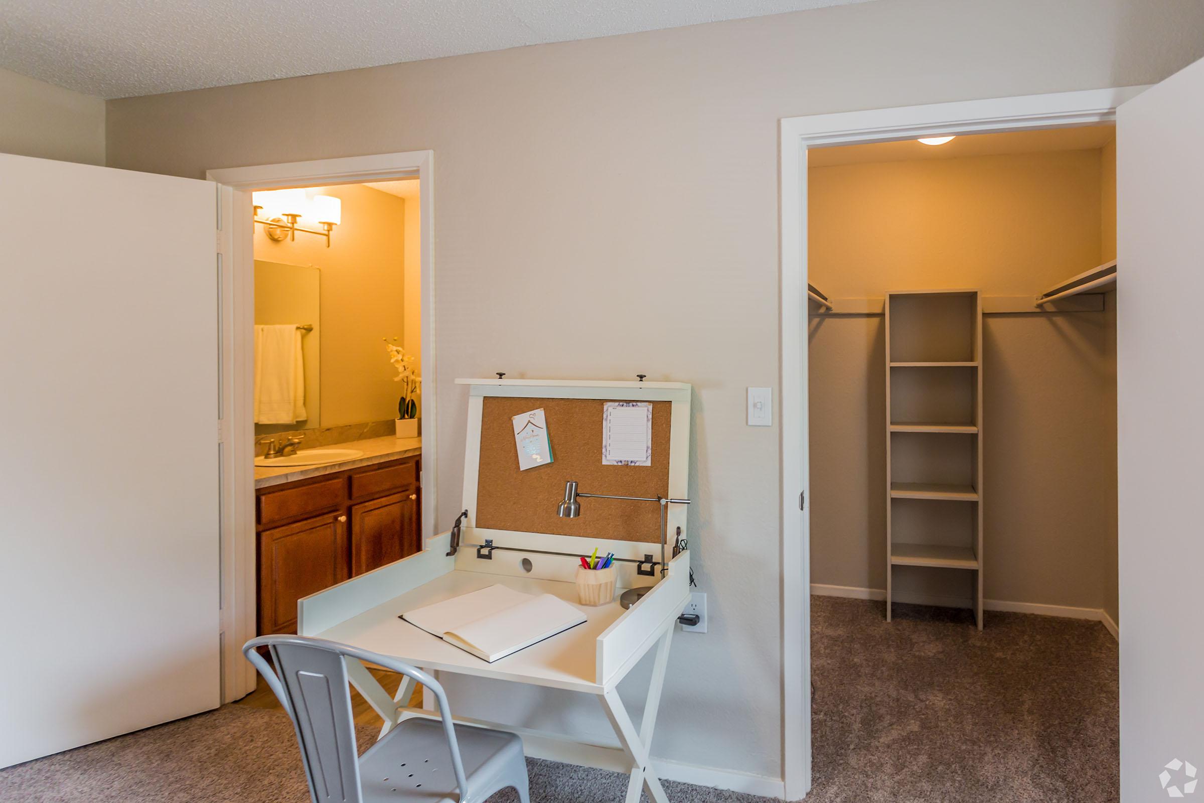 a bedroom with a bed and desk in a small room