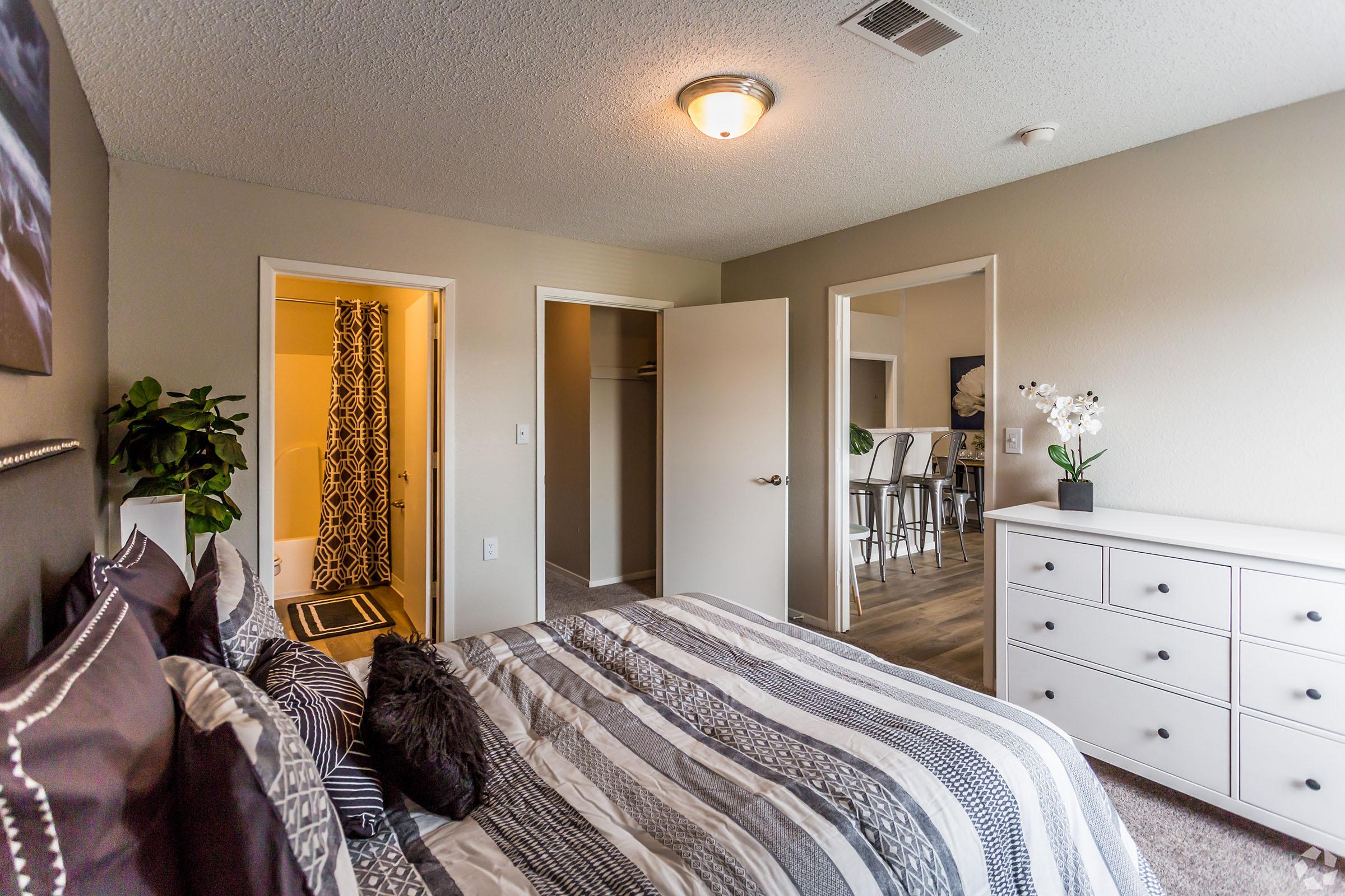 a bedroom with a bed and a mirror