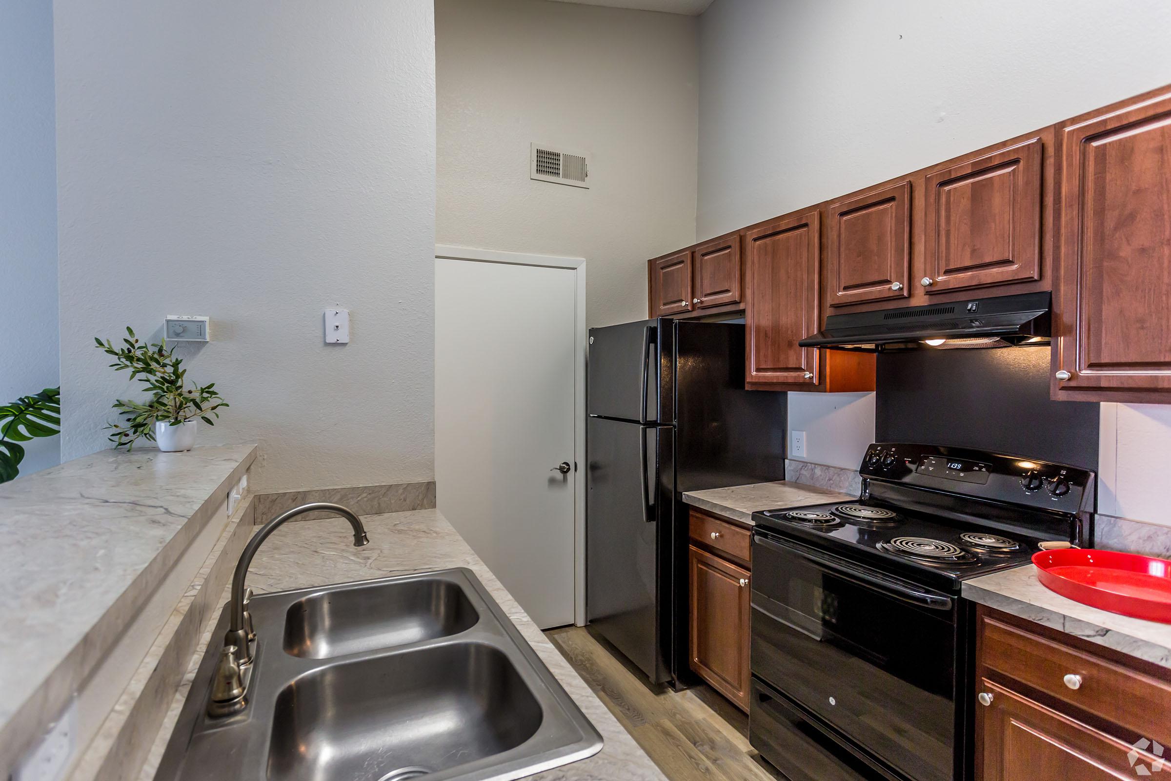 a kitchen with stainless steel appliances and wooden cabinets