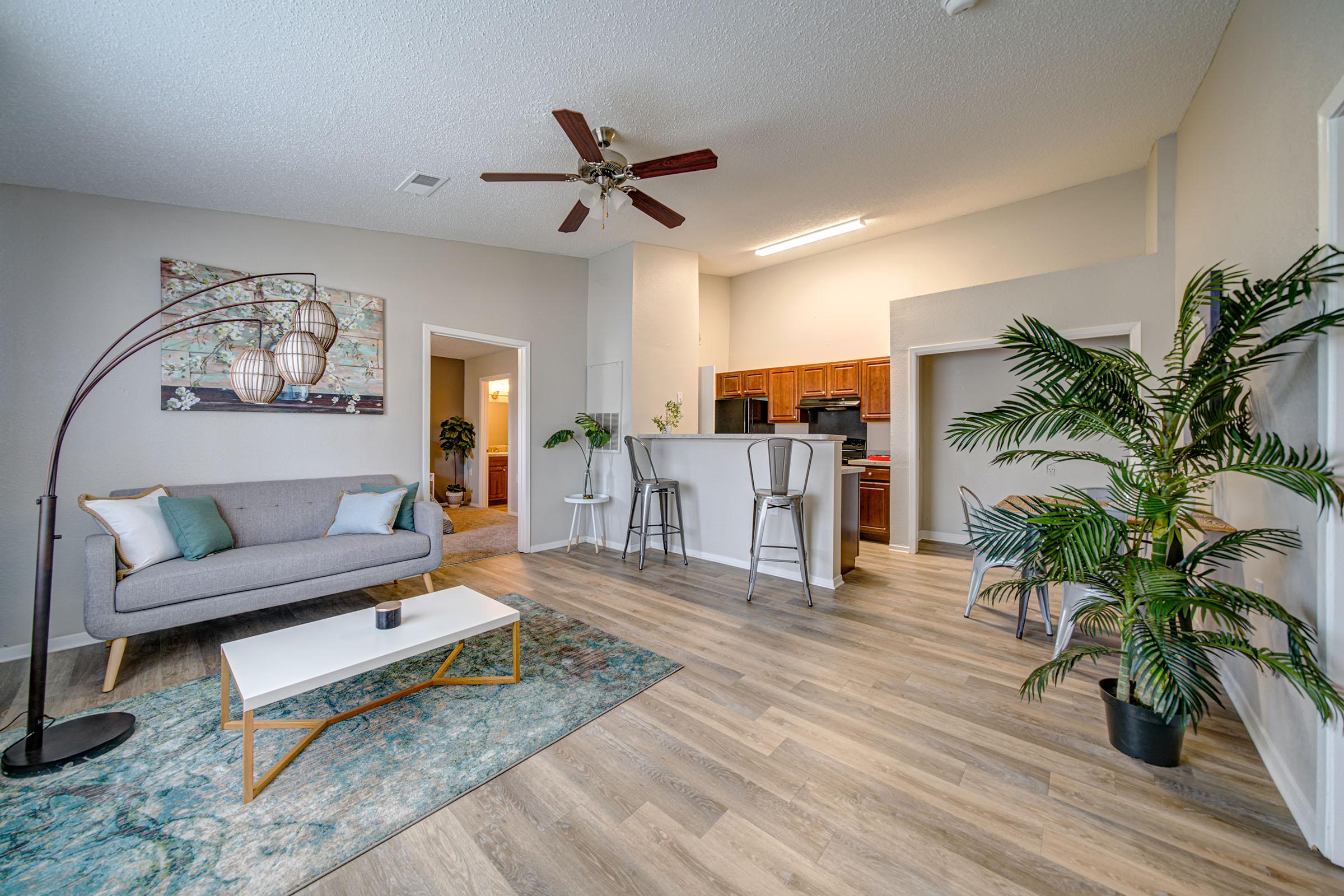 a living room filled with furniture and a large window