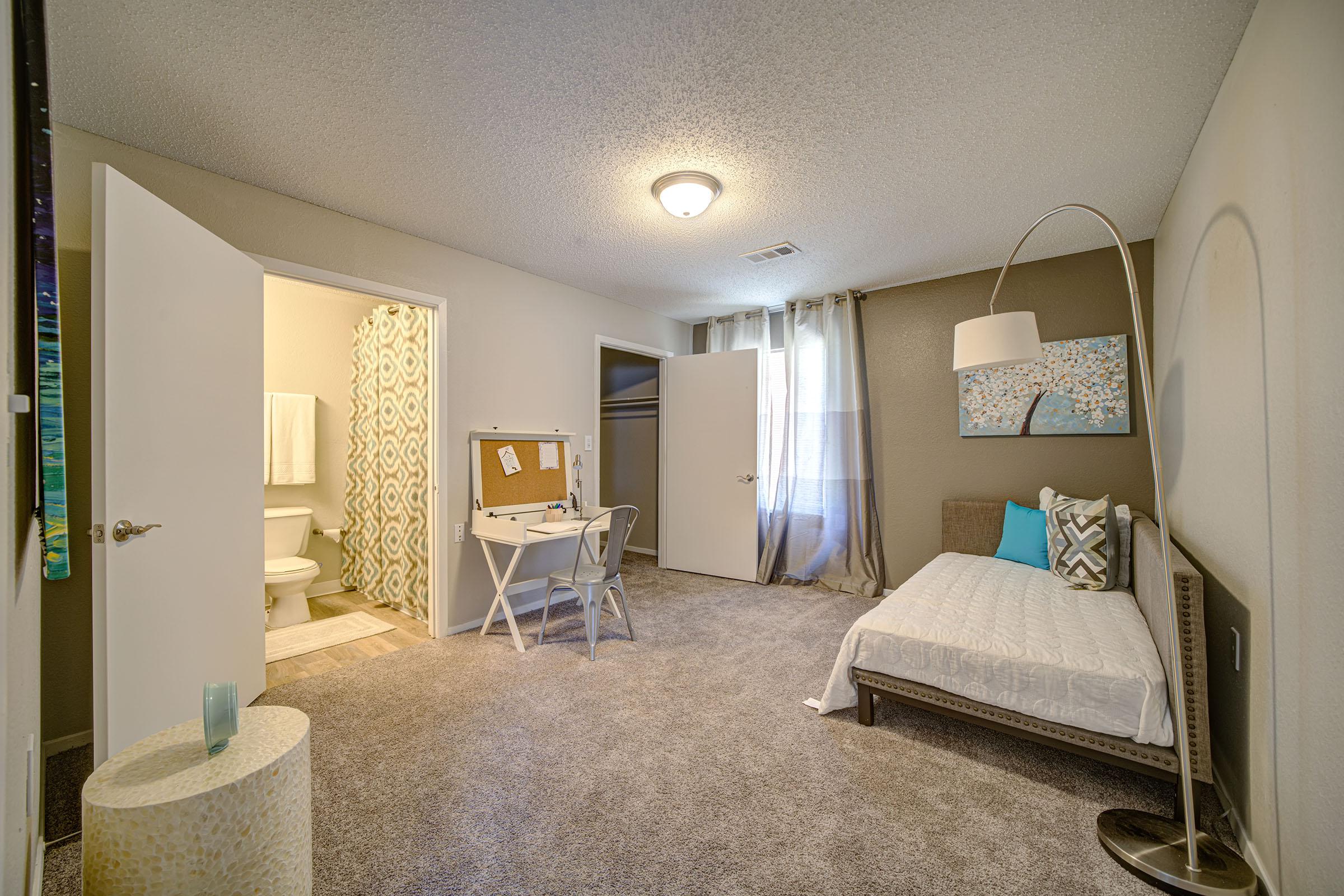 a bedroom with a bed in a room